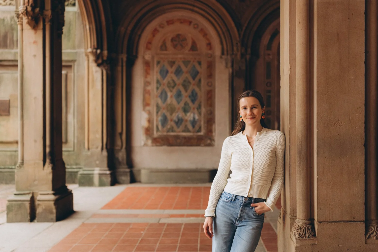 Syd smiling, leaning against a stone column in the Bethesda Terrace arcade