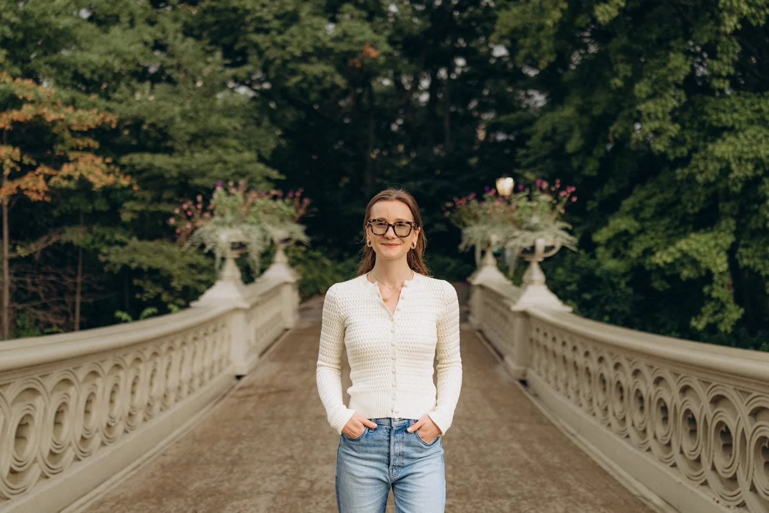 Syd standing on Bow Bridge in Central Park, smiling at the camera