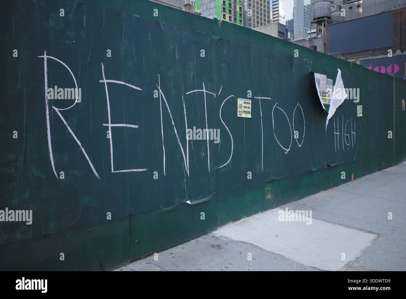 graffiti-on-a-green-plywood-construction-barrier-in-new-york-city-reads-rents-too-high-street-art-message-regarding-the-nyc-housing-crisis-3DDWTD9.jpg