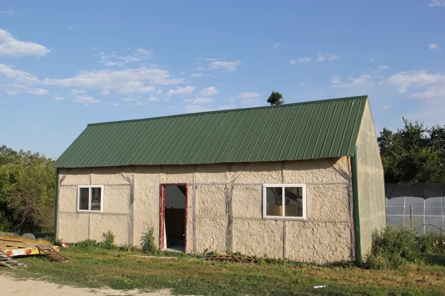 Timber frame house/shed with hemp fiber/clay wall infill, built by Slim Buttes Ag. Photo by Angelo Baca