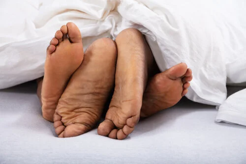 Couples feet under covers.jpg