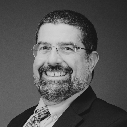 Black and white portrait of a woman with shoulder-length hair, smiling.