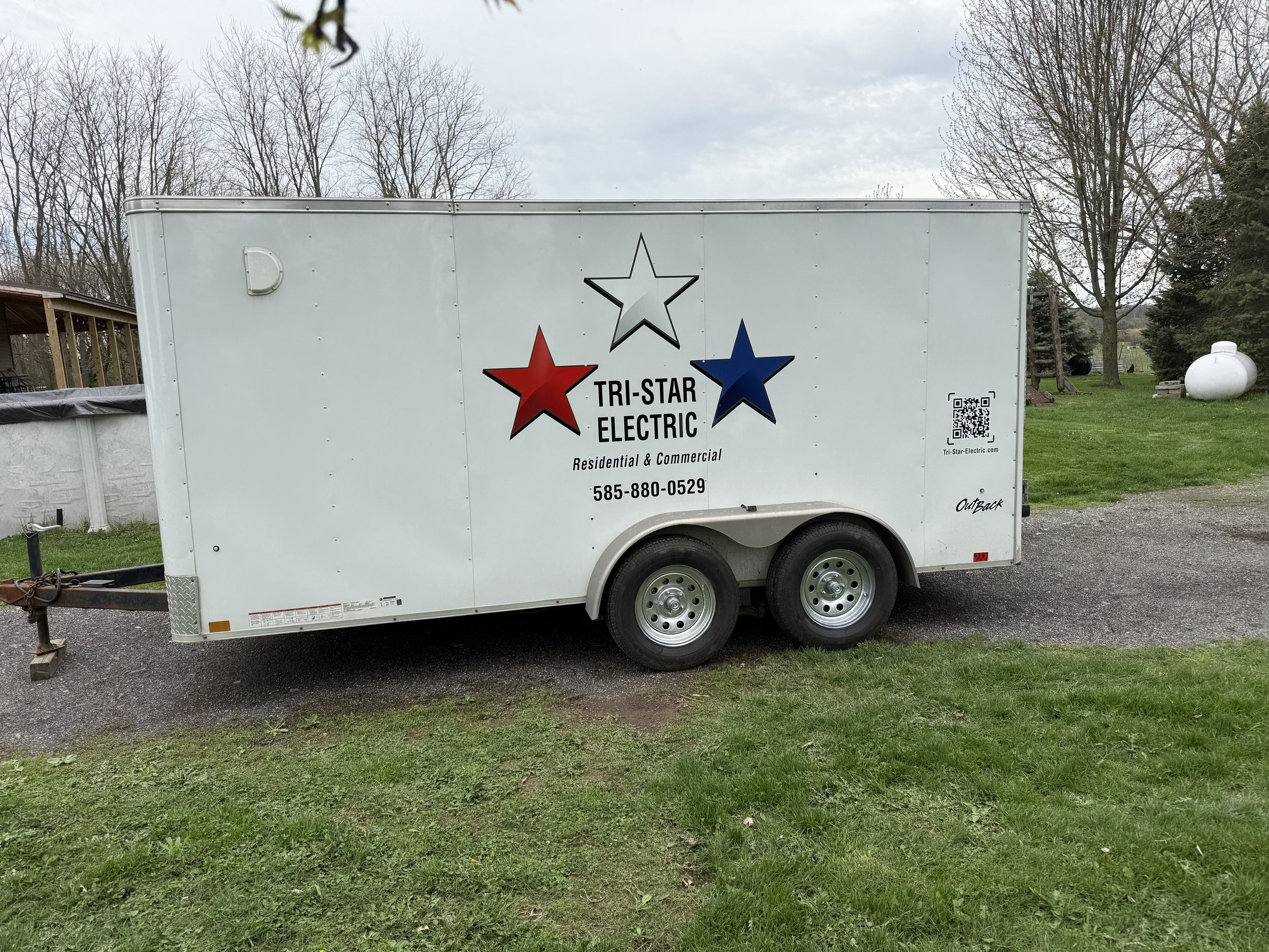 A Tri-Star Electric trailer parked at a job site in Ontario County New York.