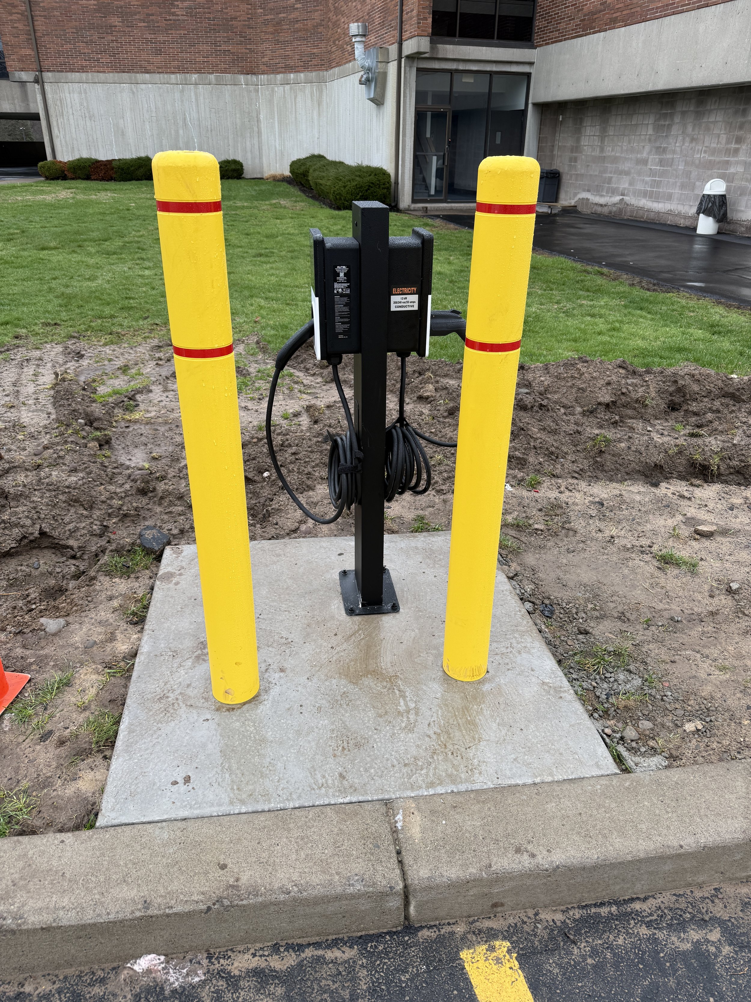 Electric vehicle charging station installed at a commercial building by Tri-Star Electric in Victor, New York.