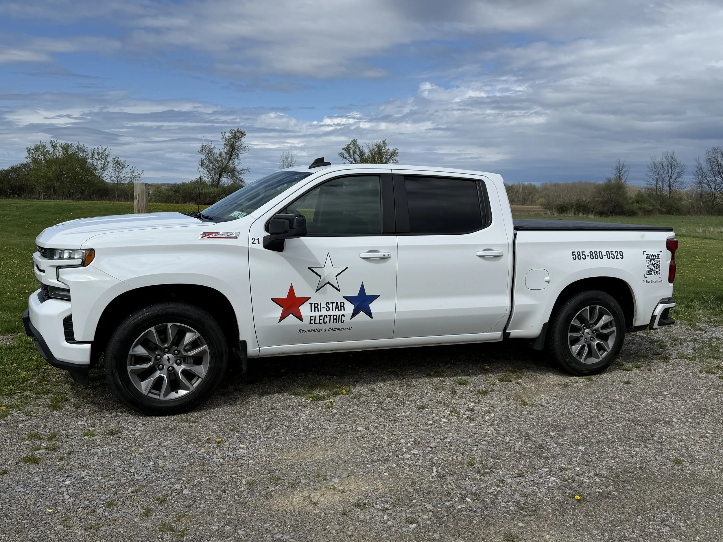 A Tri-Star Electric project manager's truck parked at a job site in Mendon, New York.