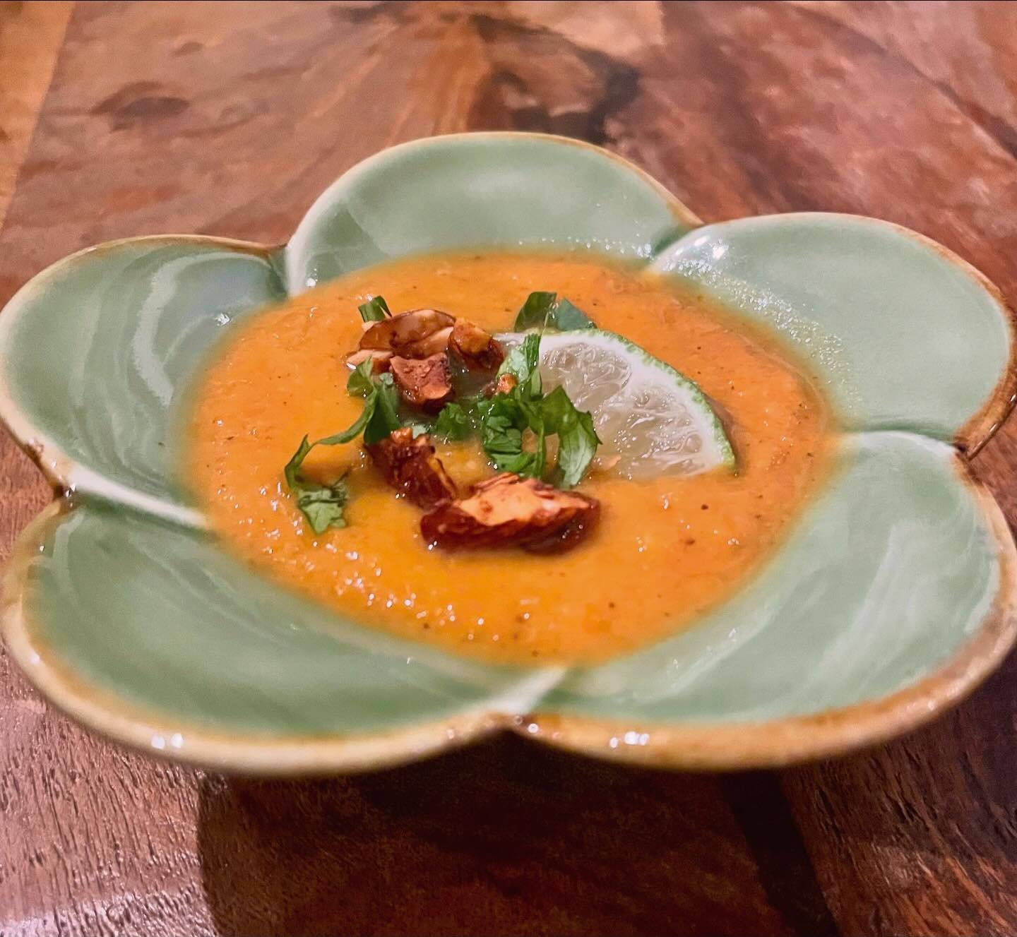 Every Monday from 5-6pm, we cook a huge pot of soup to share with people in need. Today we made a Thai inspired sweet potato and carrot soup with red curry paste and coconut milk, topped with tamari spiced almonds, cilantro and lime. Our regulars wer