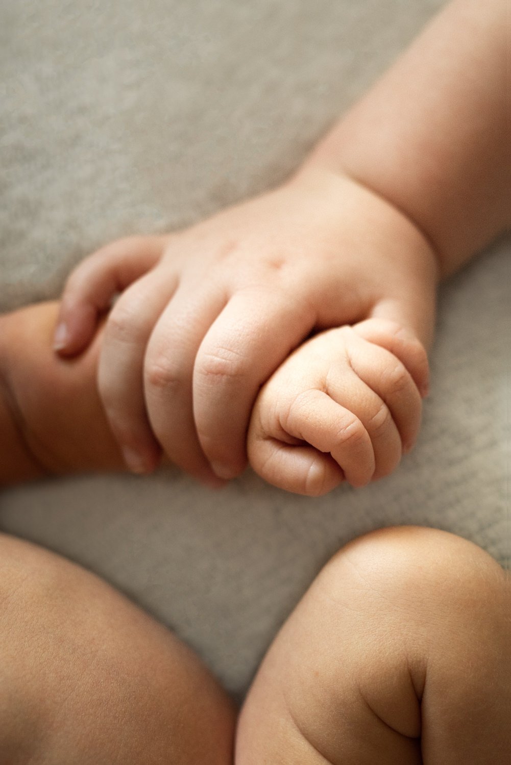 Sibling Holding Baby's Hand