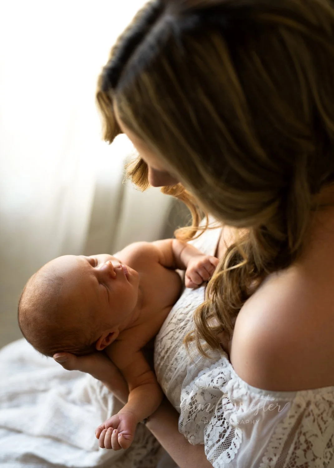 Mom Looking Down At Newborn