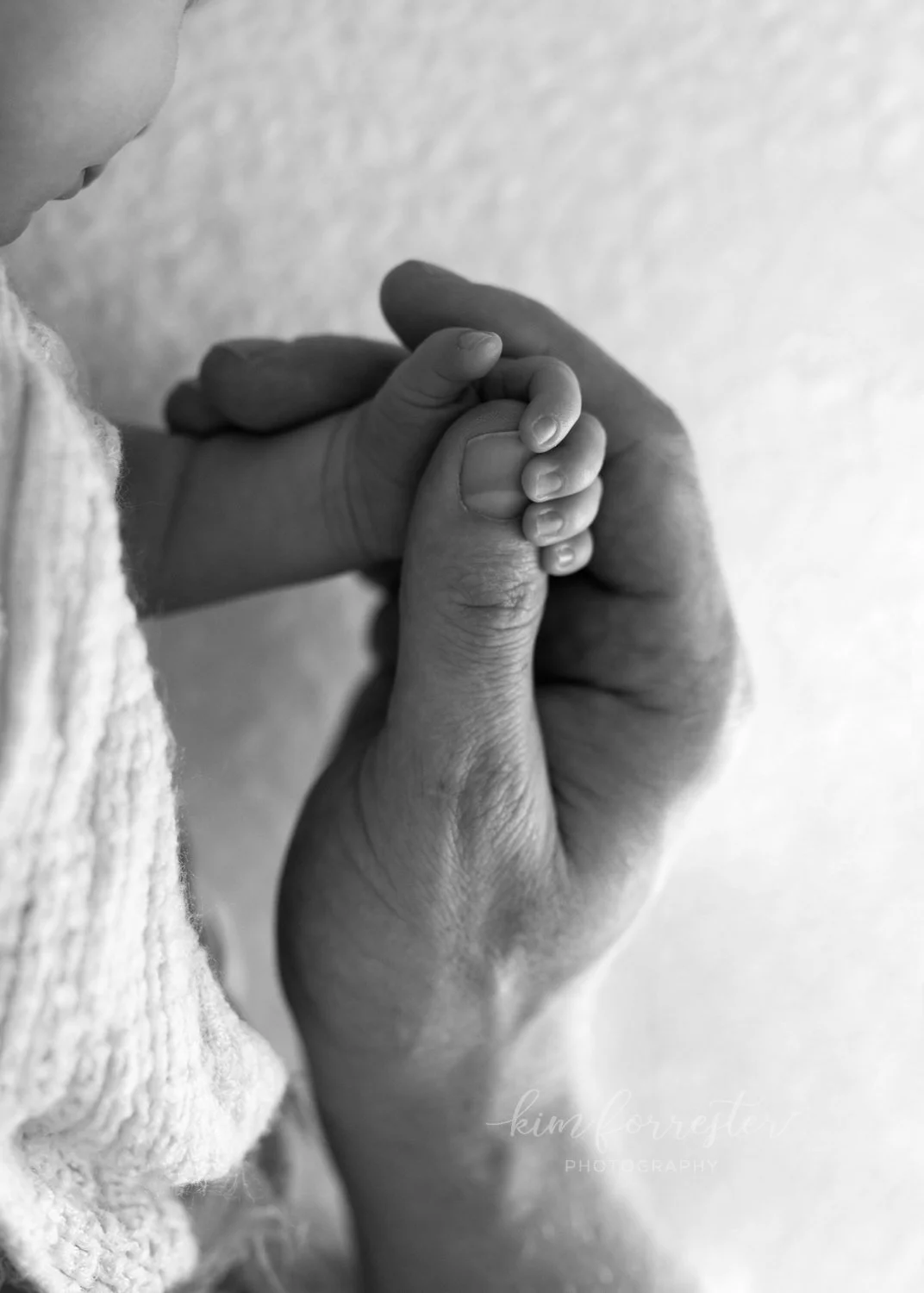 Newborn Holding Dad's Thumb