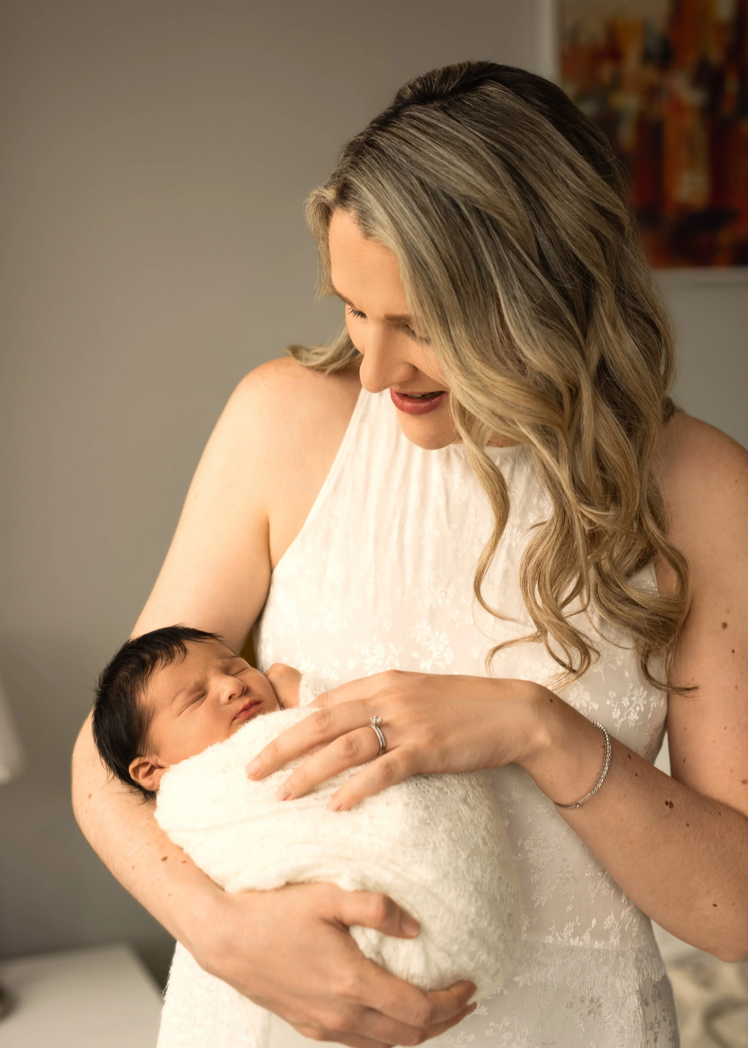 Wrapped Newborn Held By Mom