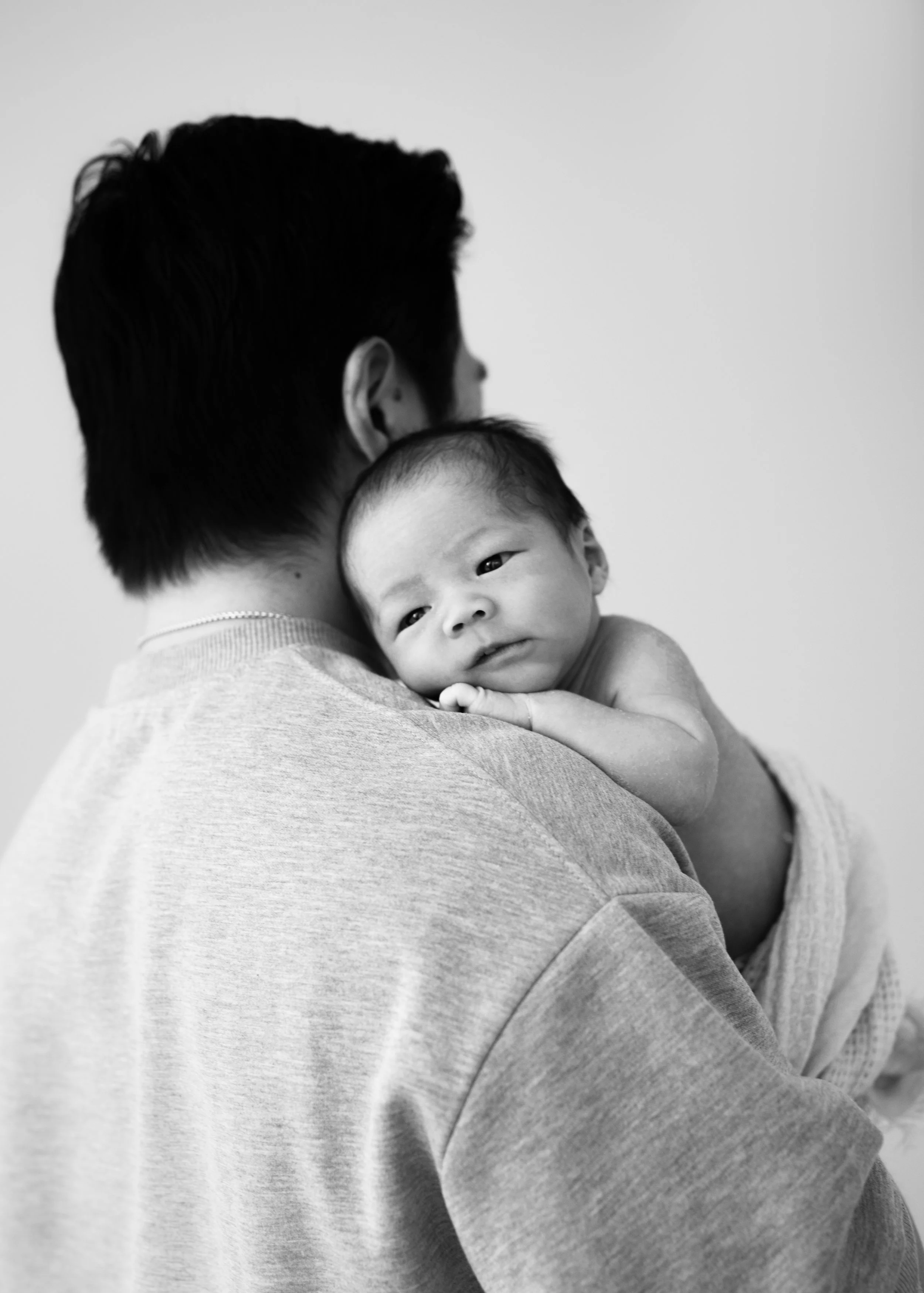 Newborn on Dad's Shoulder