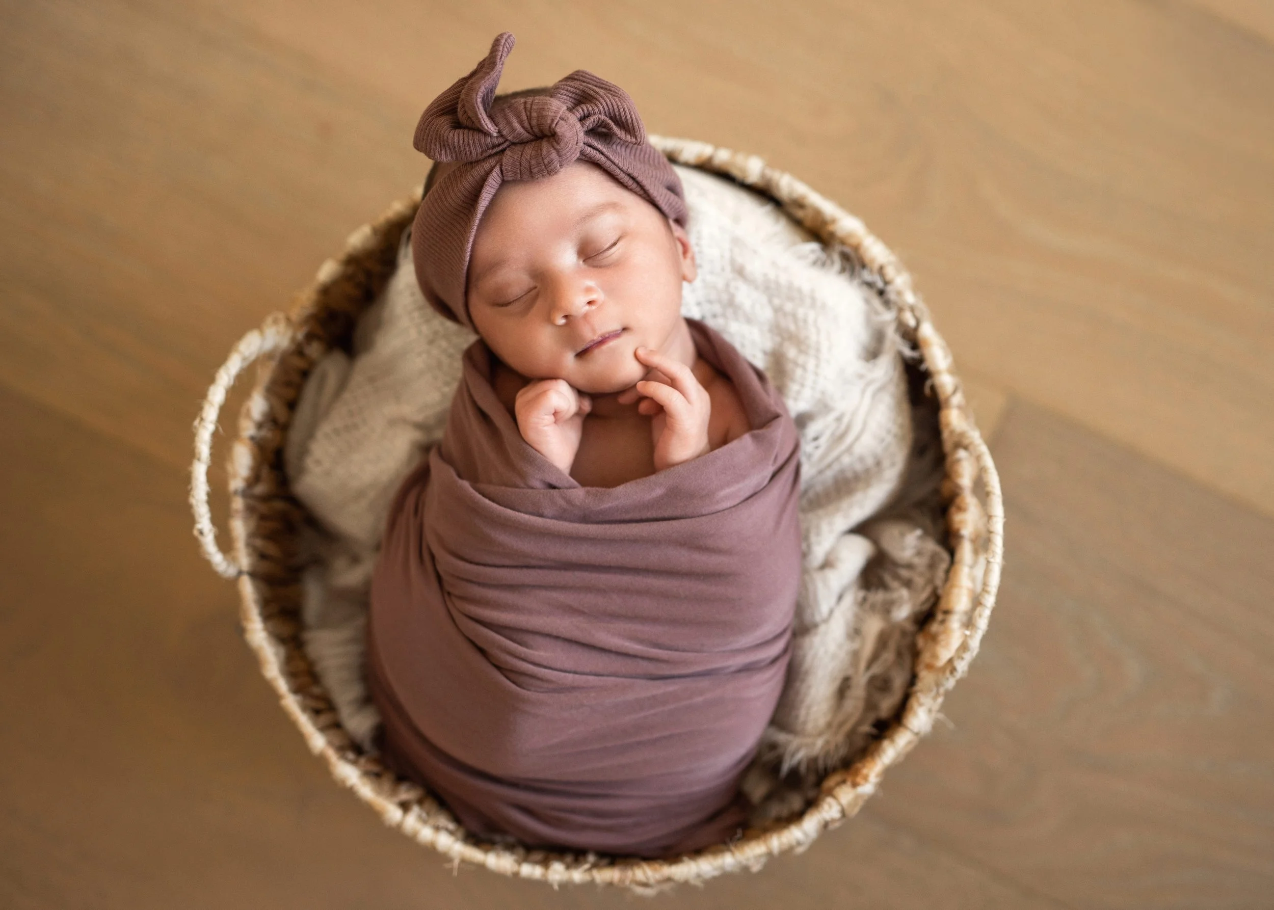 Newborn Wrapped in Purple in Basket-Pose