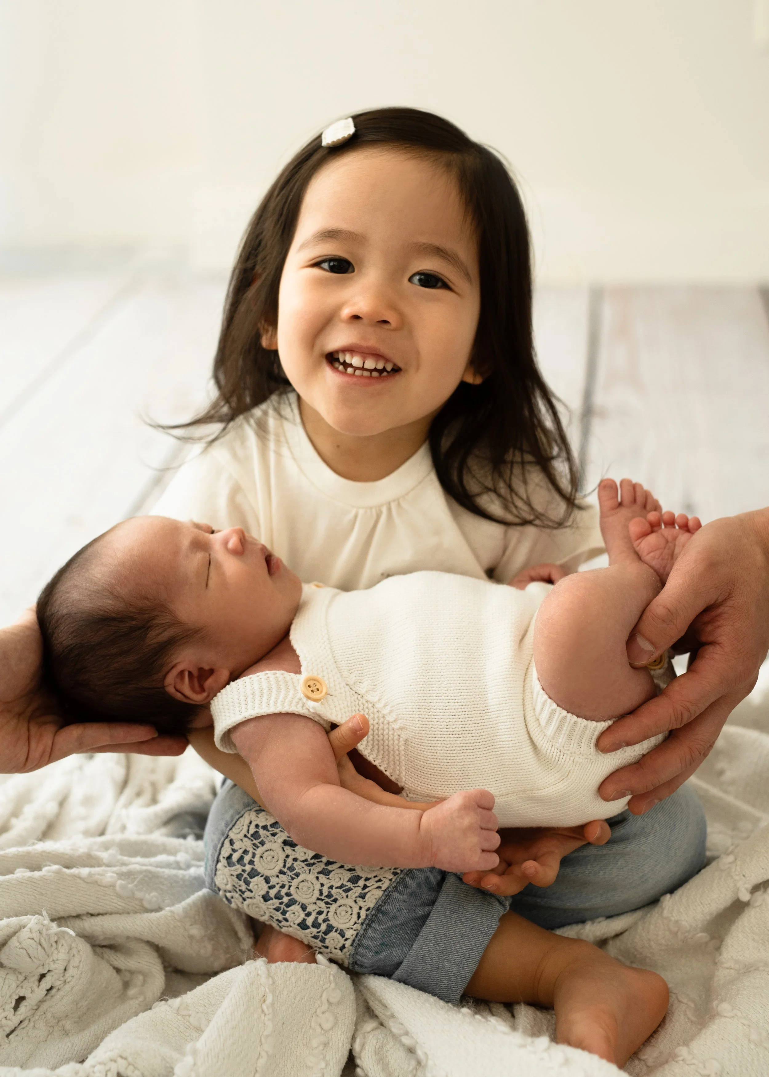 Big Sister Holding Newborn
