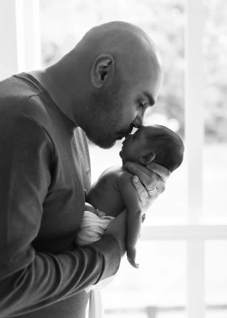 Dad Kissing Newborn on Forehead