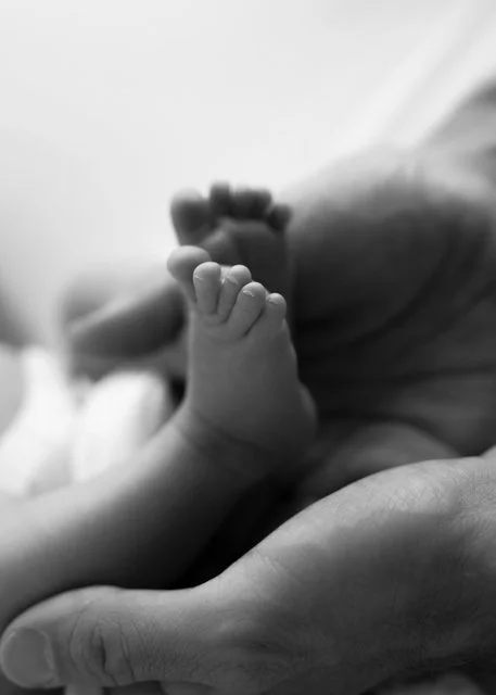 Black-and-white closeup newborn feet