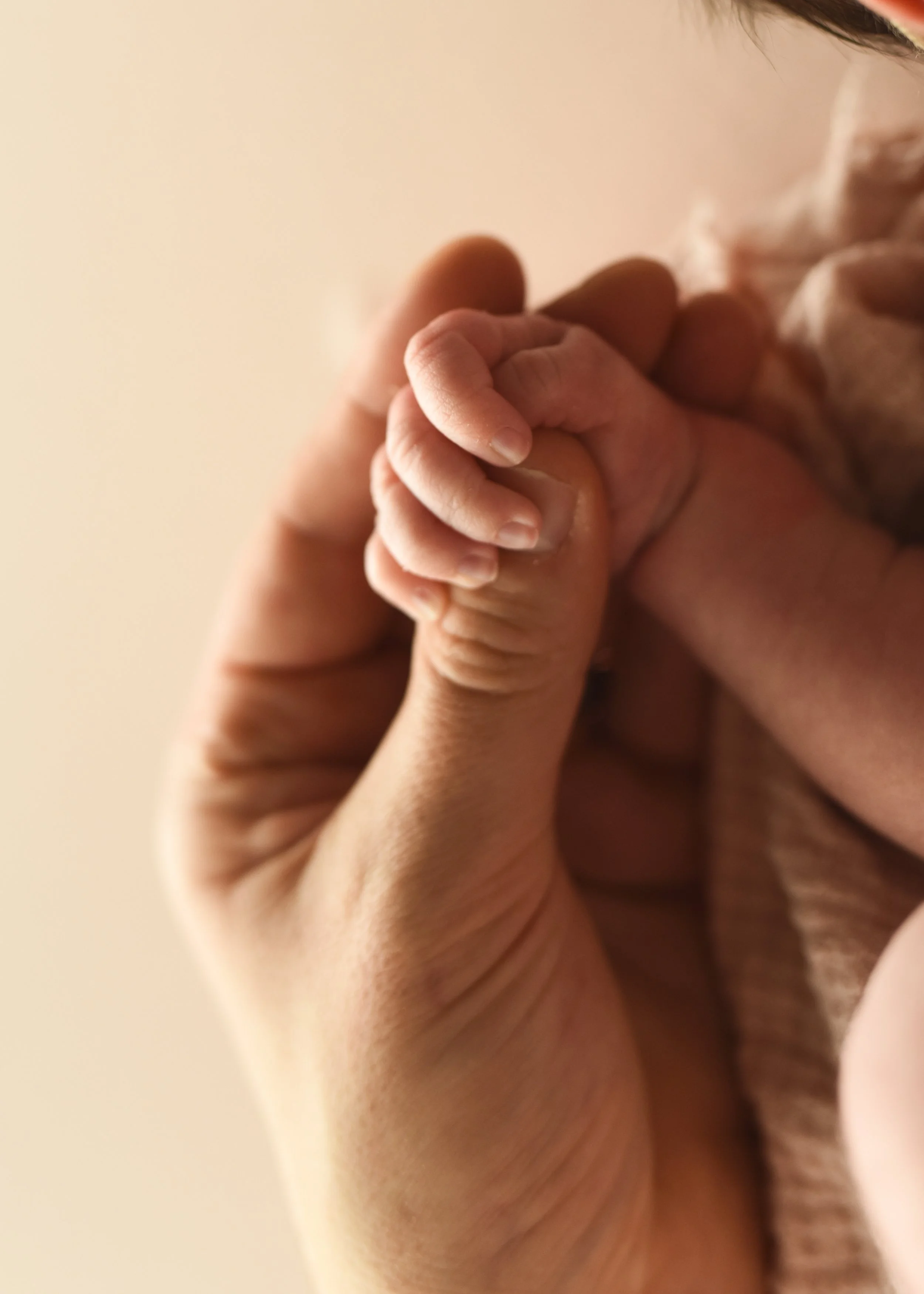 Newborn Holding Dad's Thumb