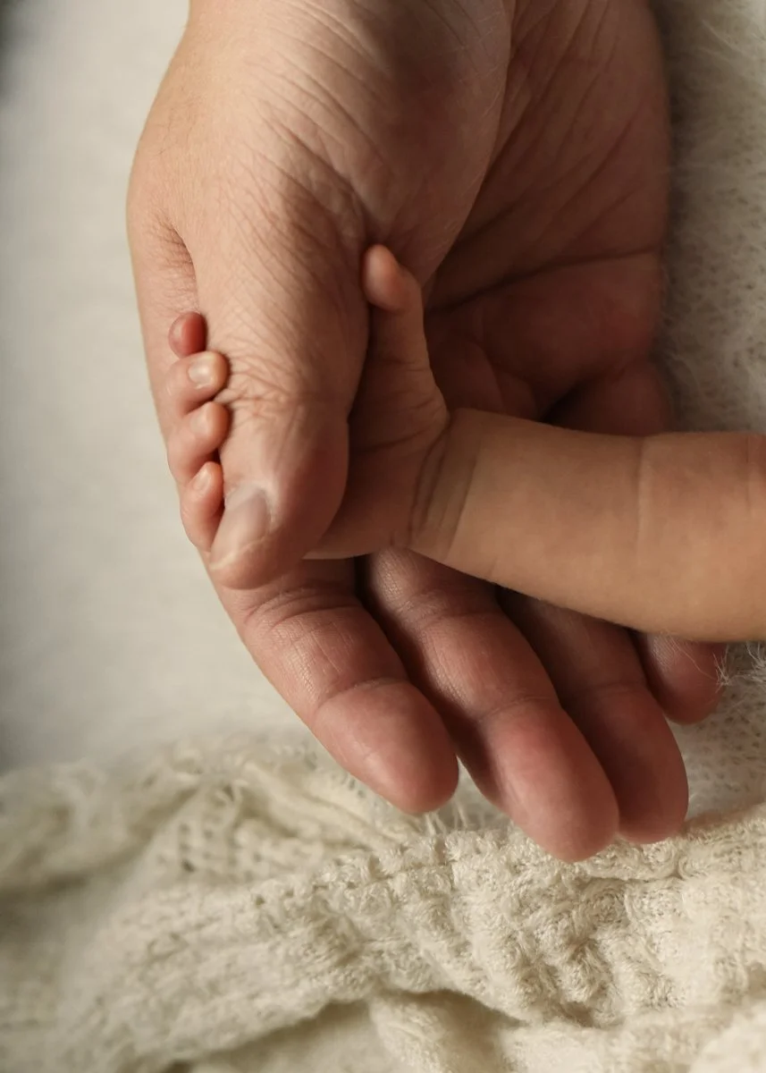 Newborn and Dad Hands Close-up