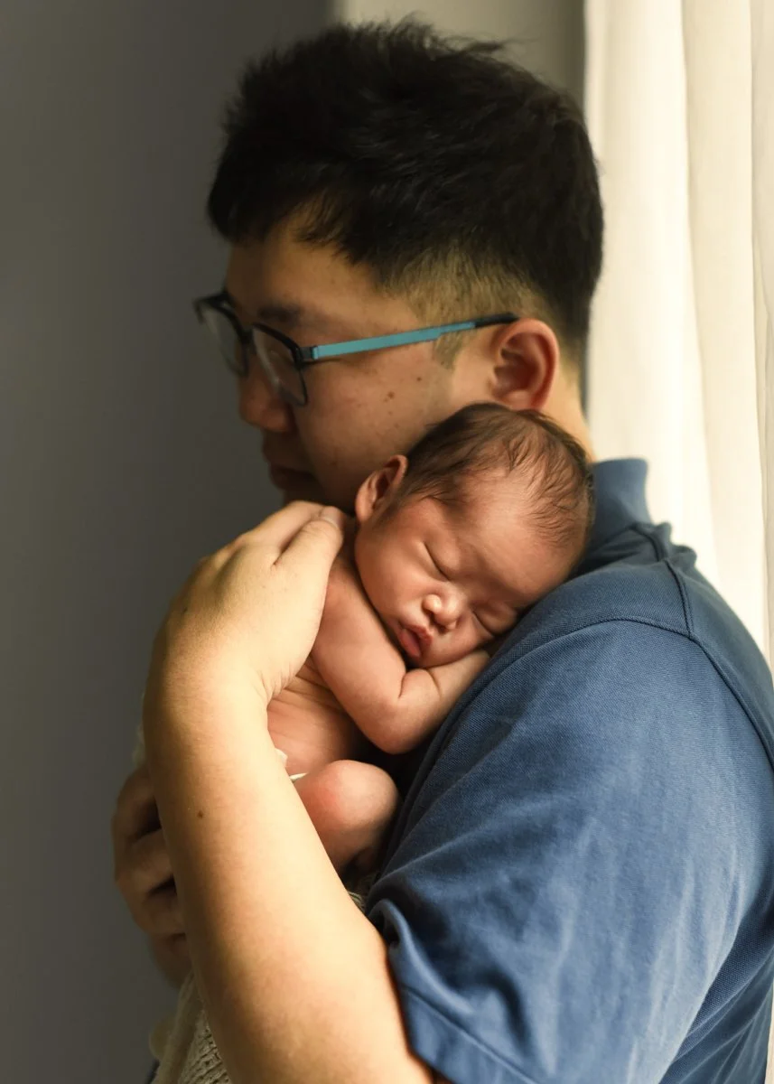 Dad Holding Newborn in Vancouver