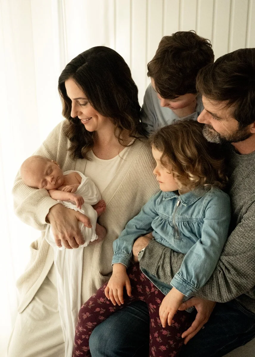 Kelowna In-Home Newborn Photography | Family Holding Newborn