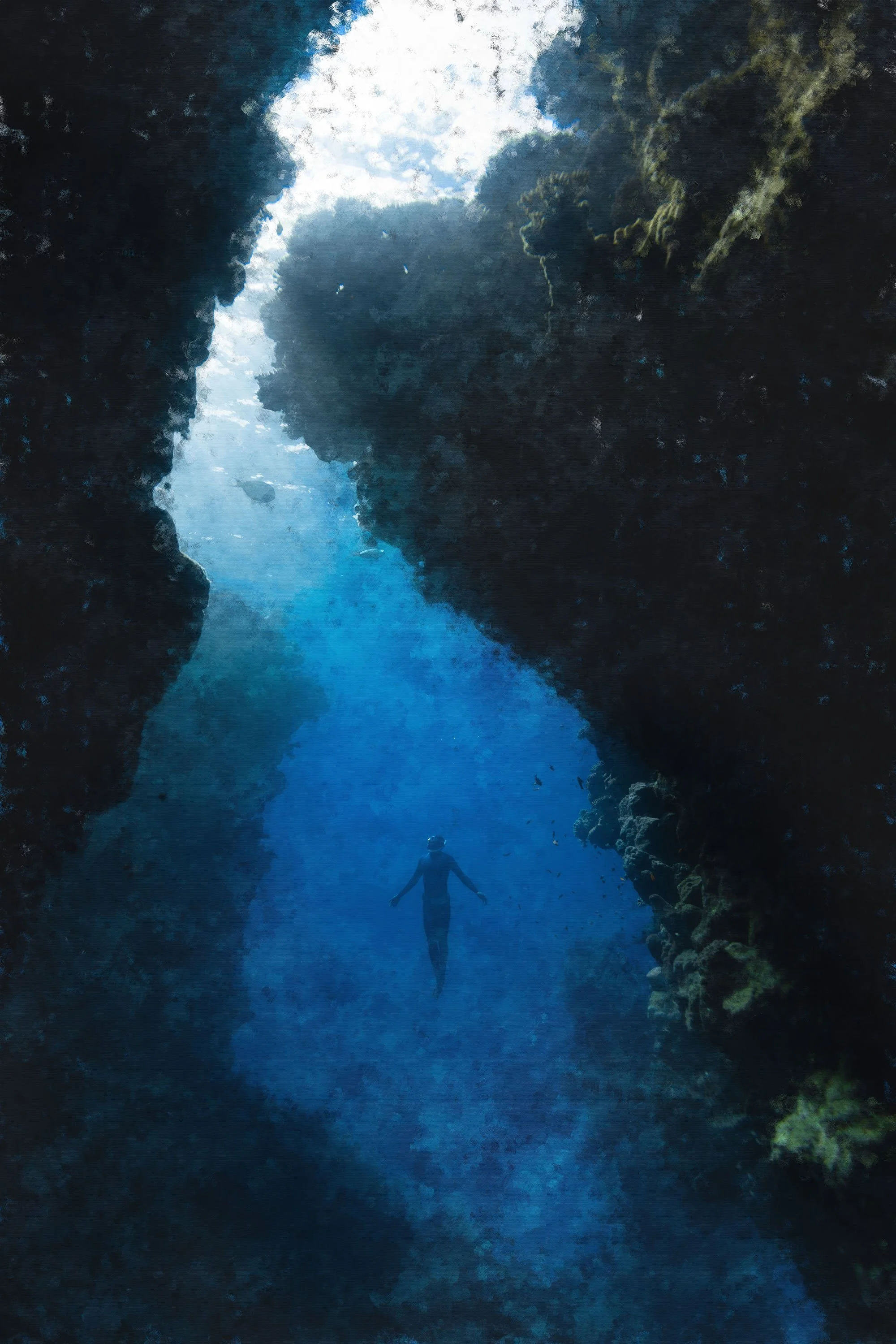 A person scuba diving in a deep, narrow underwater canyon with rocky walls and sunlight shining from above.