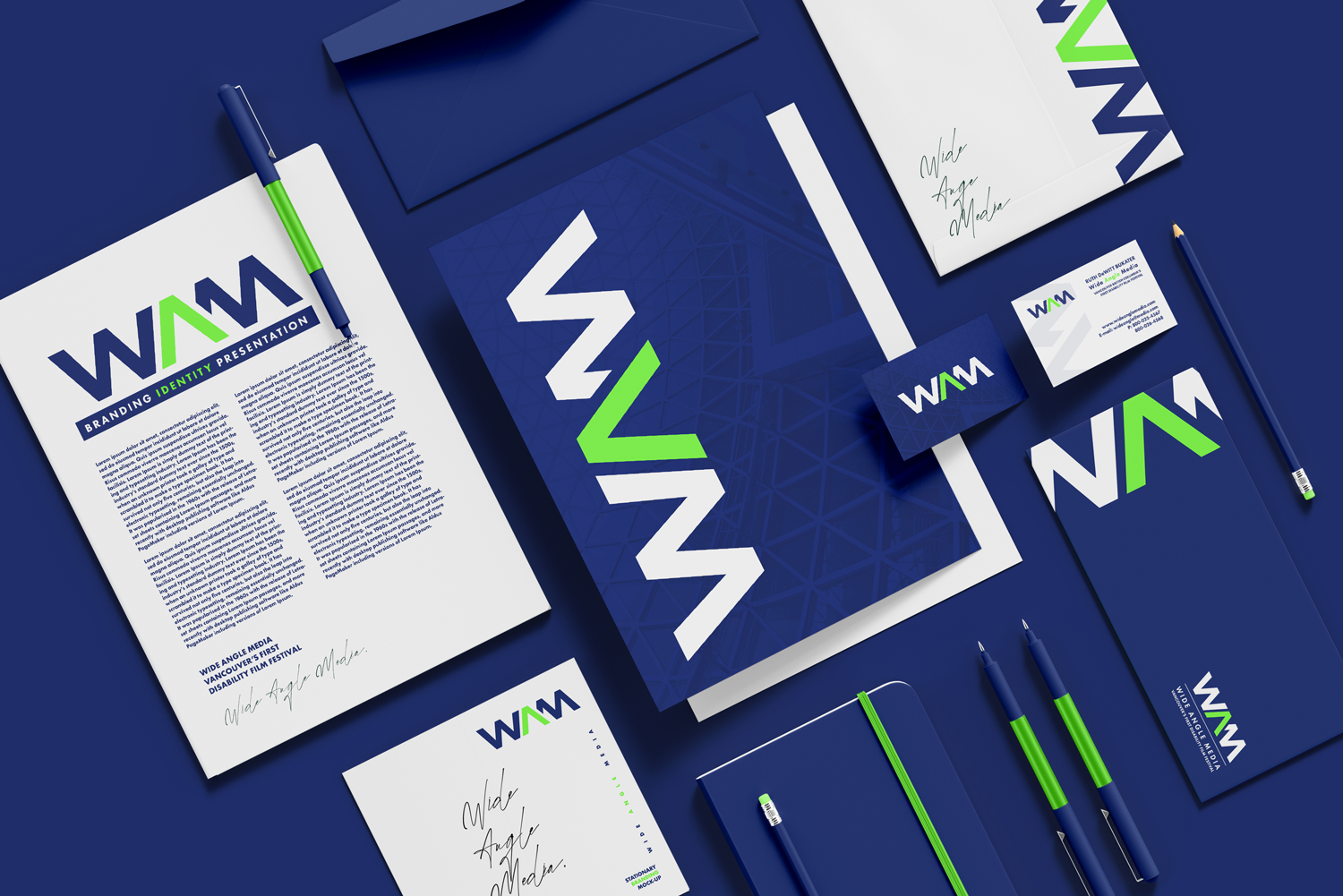 Branded media and stationery items for Wide Angle Media, including a letter, business card, notebooks, pens, and a brochure with a blue, green, and white color scheme featuring their logo.