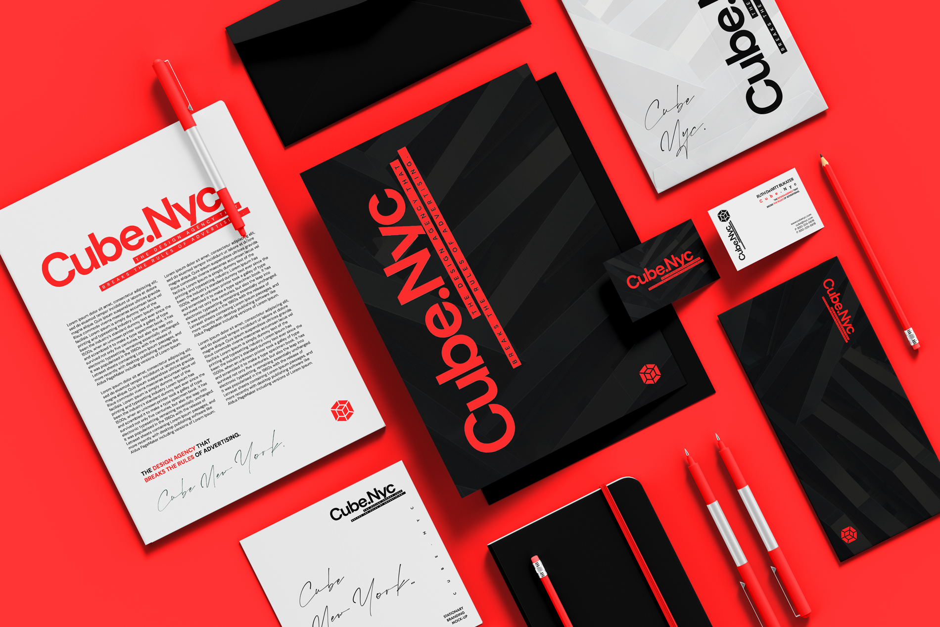 A collection of branding materials for Cube.Nyc, including a white paper with red text, black folders, business cards, notebooks, pens, and envelopes, all featuring the Cube.Nyc logo and a black and red color scheme, arranged on a red background.