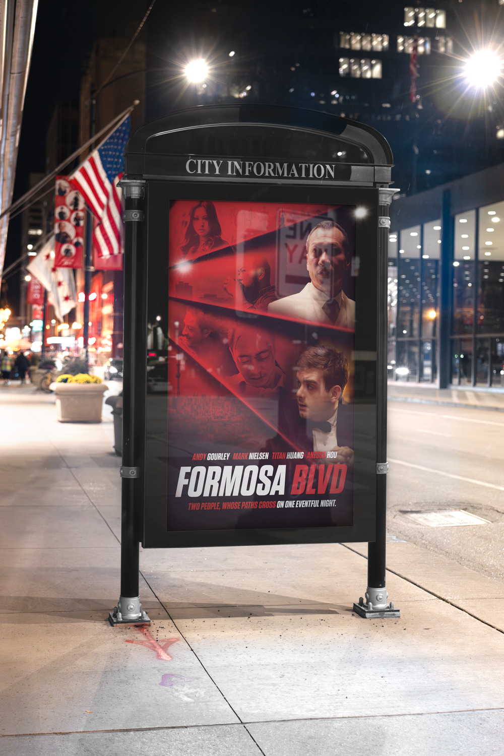 Poster advertising a film on a city street at night, featuring images of actors and text.
