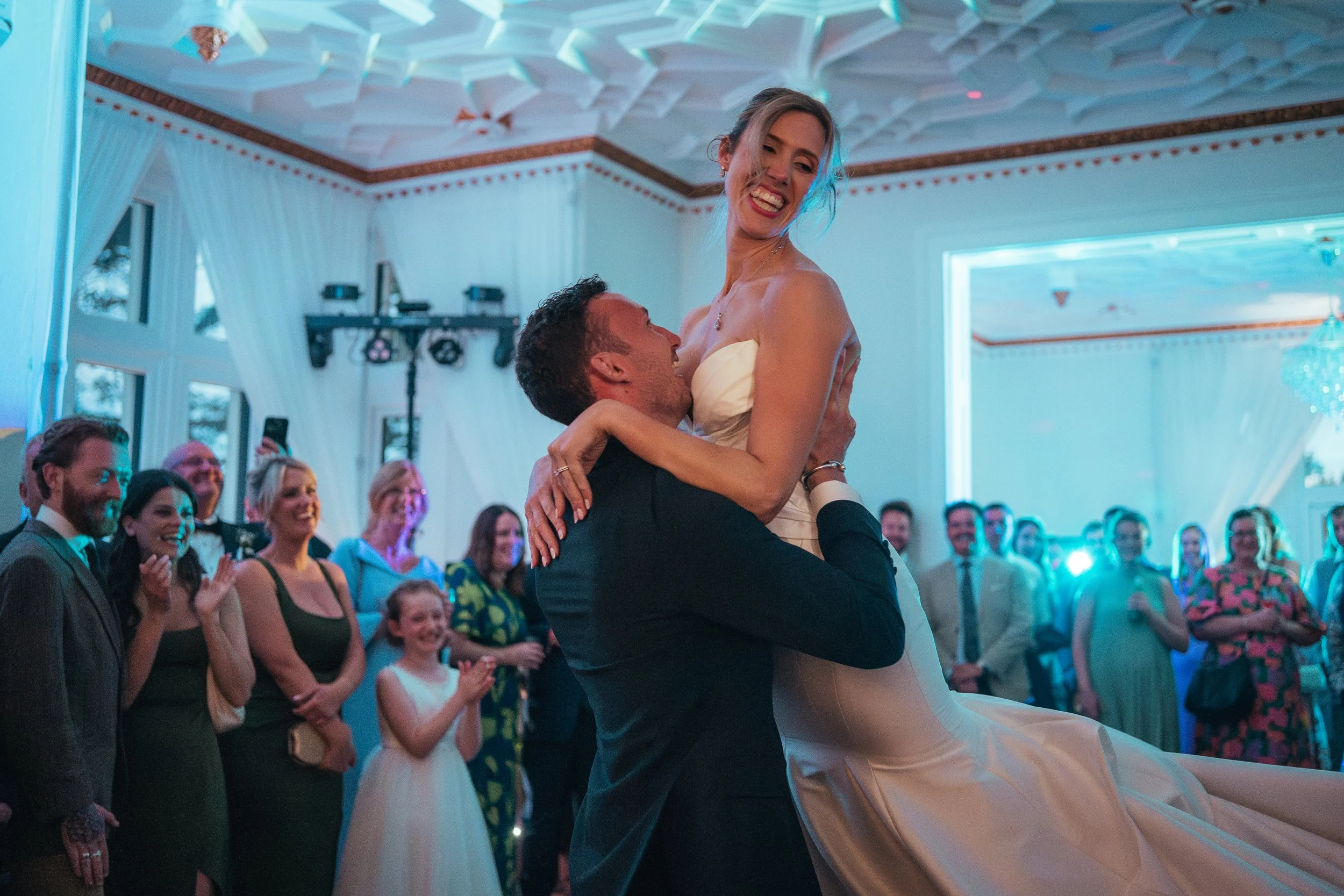 bride being lifted by her new groom during their first dance.
