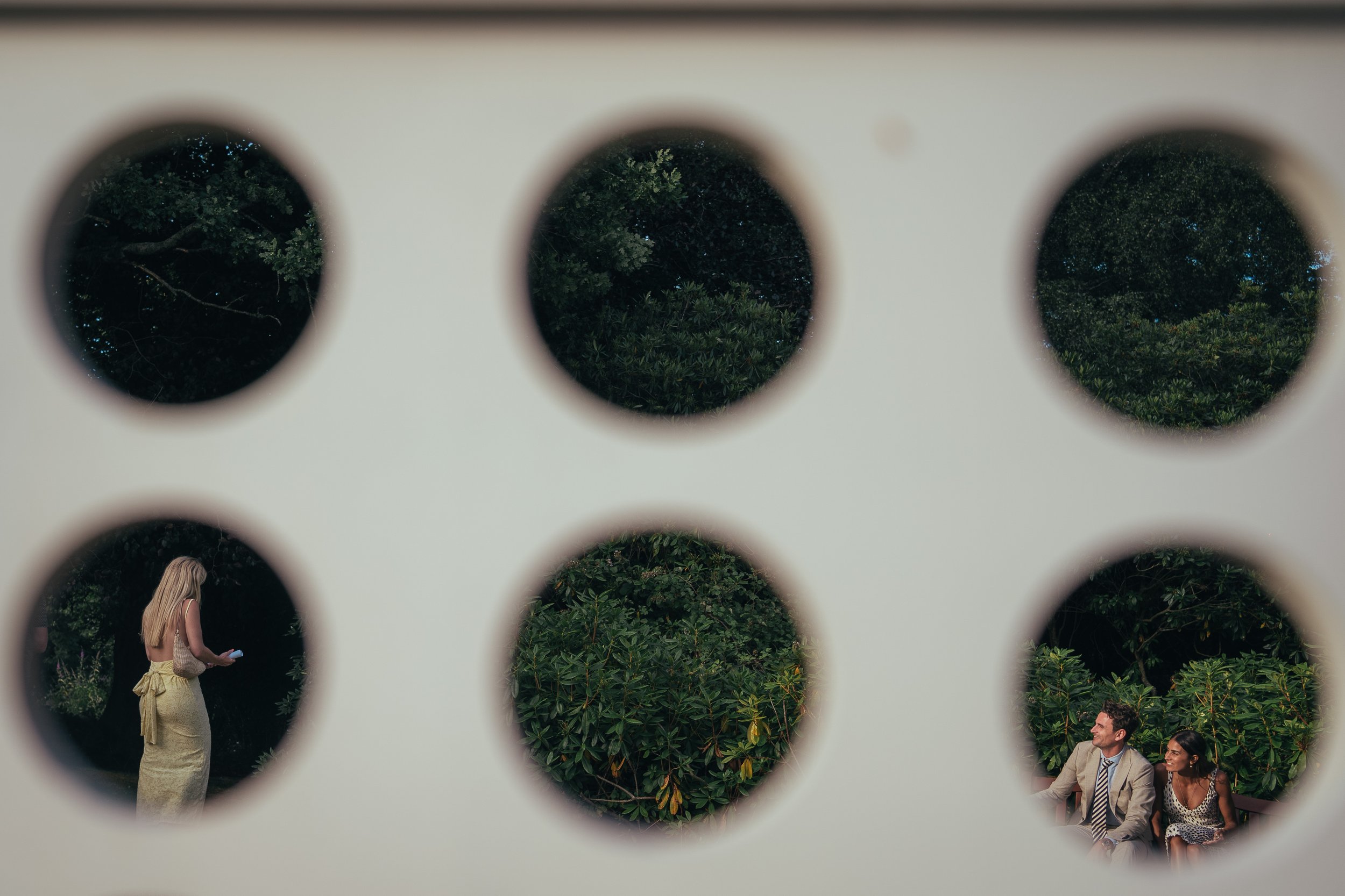 Candid documentary wedding photo shot through an outdoor wedding game. 