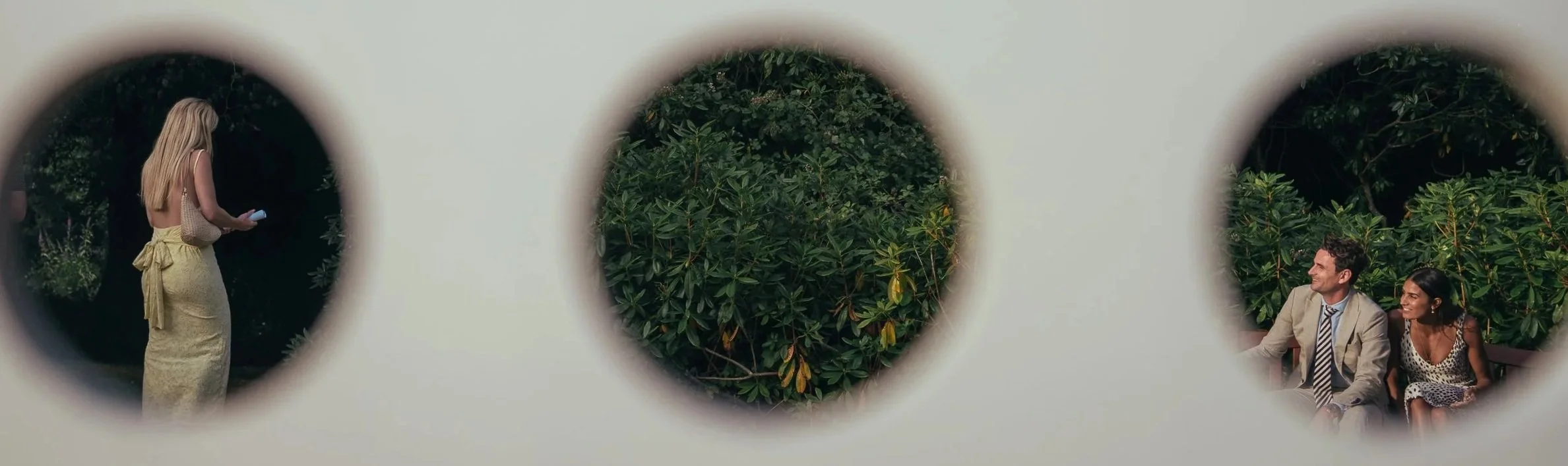 creative image of wedding guests through a connect four garden game at a summer wedding.