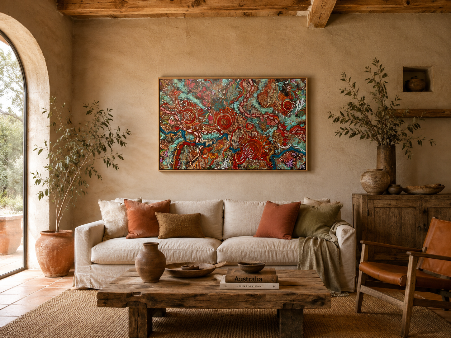 vibrant Indigenous Australian landscape artwork styled in a rustic Australian homestead interior, with earthy ochre tones, turquoise highlights, journey lines, meeting places, native-inspired details and a slim oak floating frame.