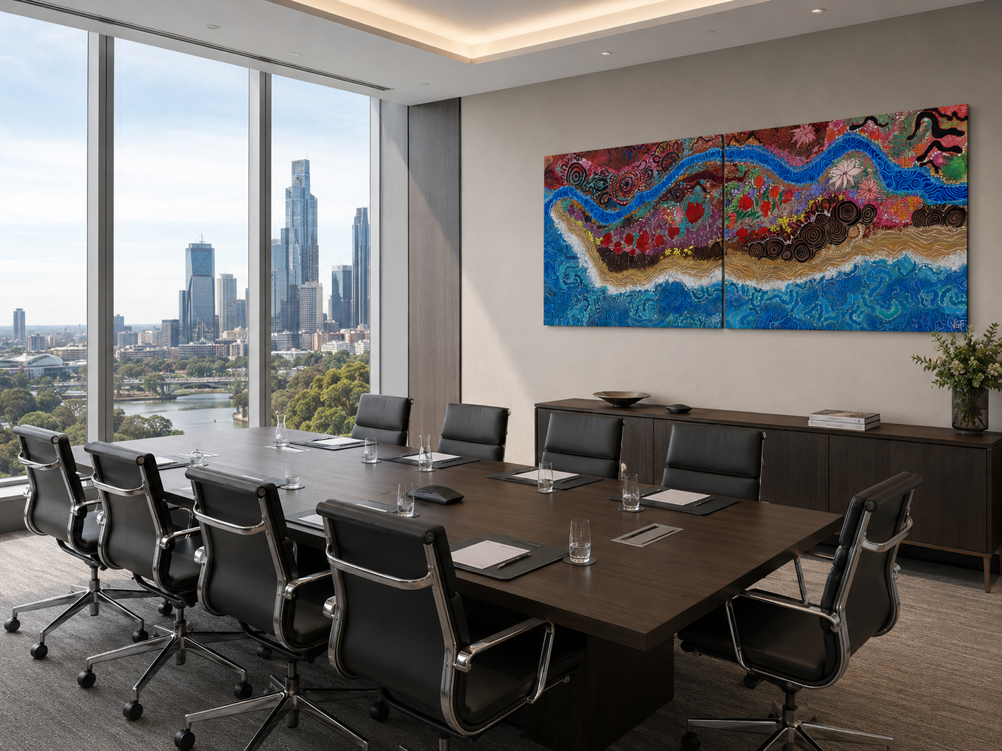 Russel Kennedy Lawyers - Commissioned Artwork - Modern conference room with a large wooden table, black leather chairs, a large colourful abstract Indigenous / Aboriginal painting on the wall, and a view of Melbourne outside the window.