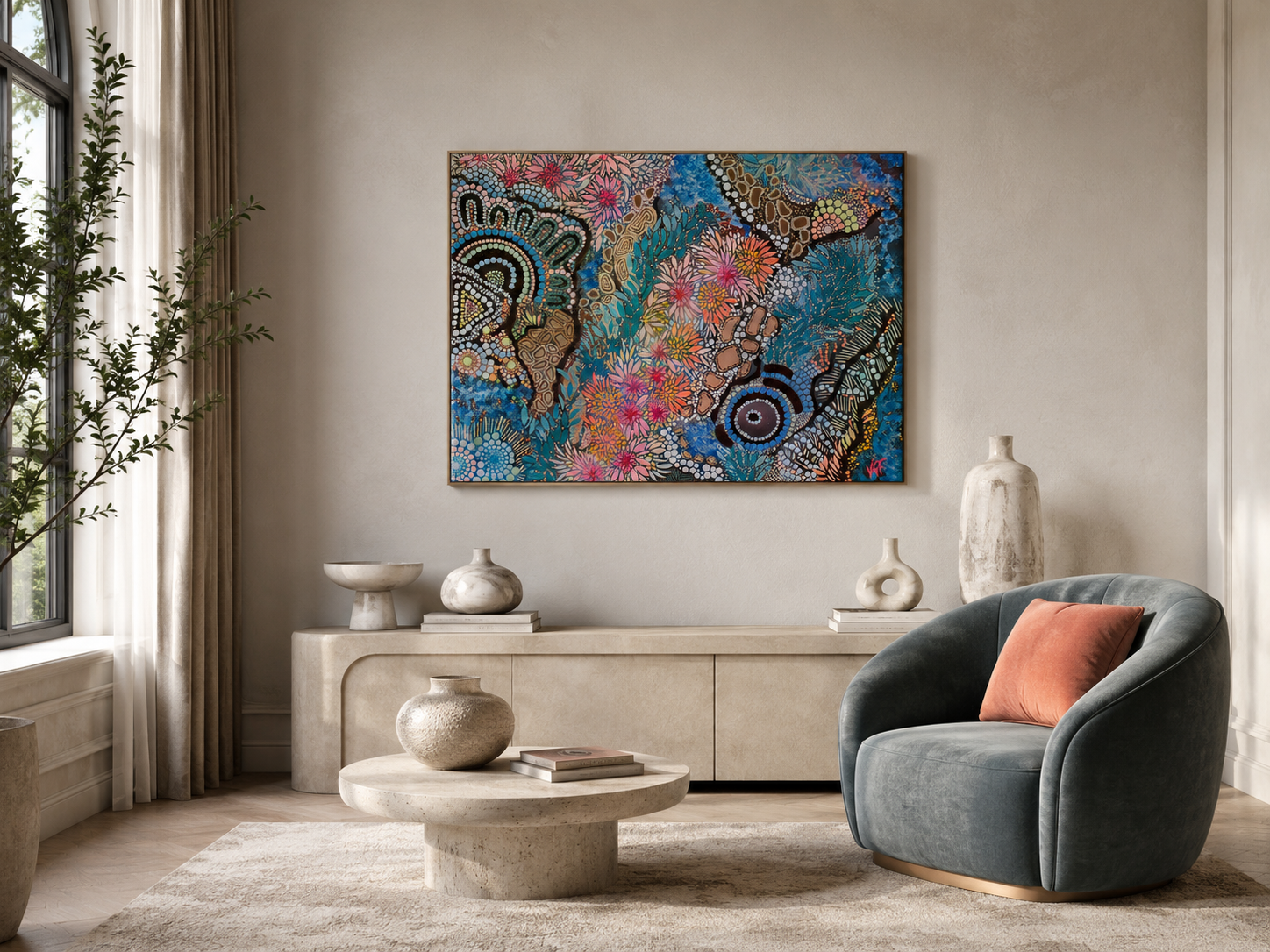 Living room with a beige sideboard, decorative vases, a round coffee table, a gray armchair with a rust-colored pillow, large window with curtains, an abstract colourful Indigenous painting on the wall, and a potted plant.