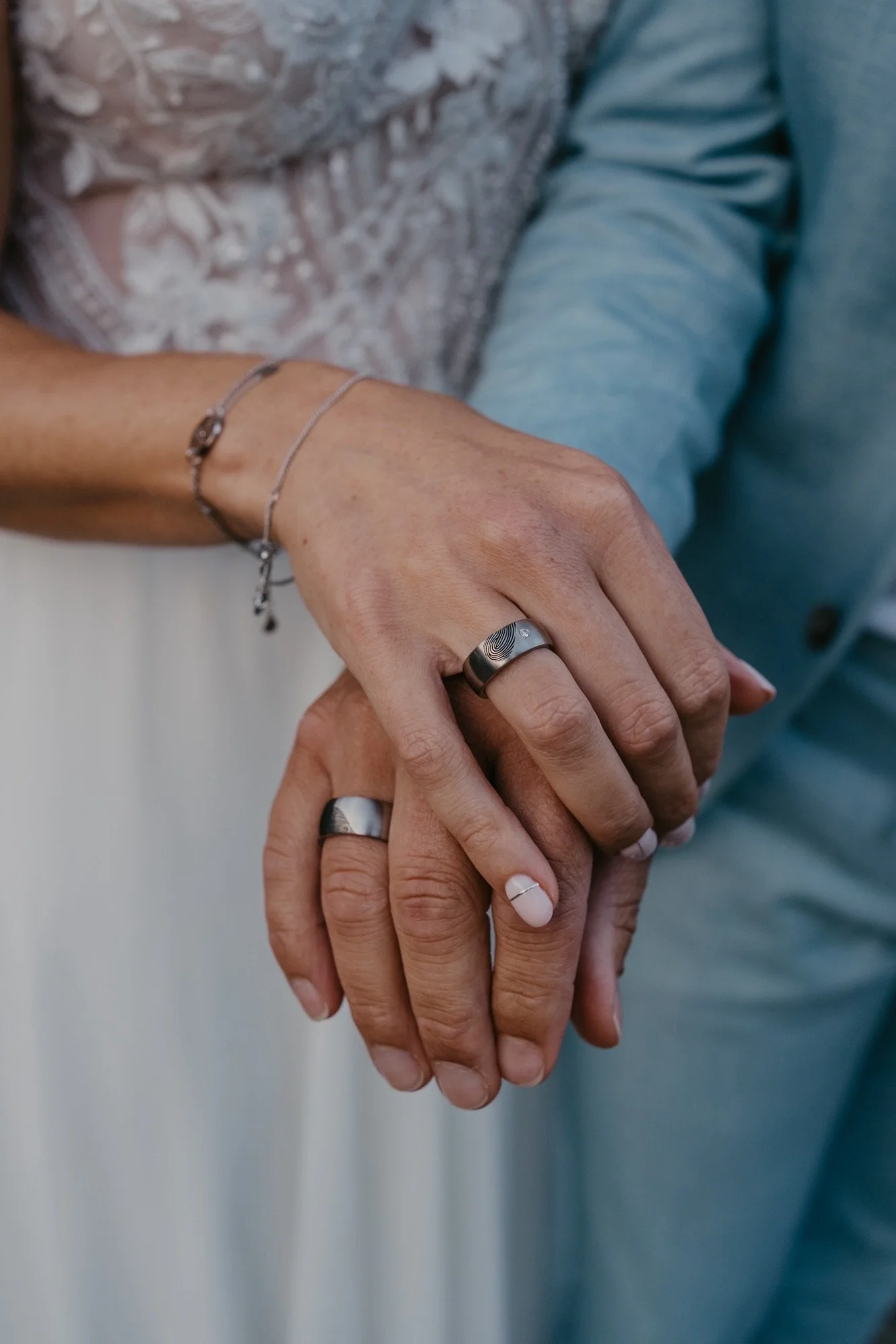 Bekijk deze trouwfoto waarop het bruidspaar hun unieke vingerafdrukringen bewondert, vervaardigd door [Uw Bedrijfsnaam]. Onze handgemaakte ringen, met de vingerafdruk van uw partner, symboliseren de bijzondere band die u deelt. Als specialist in gepe