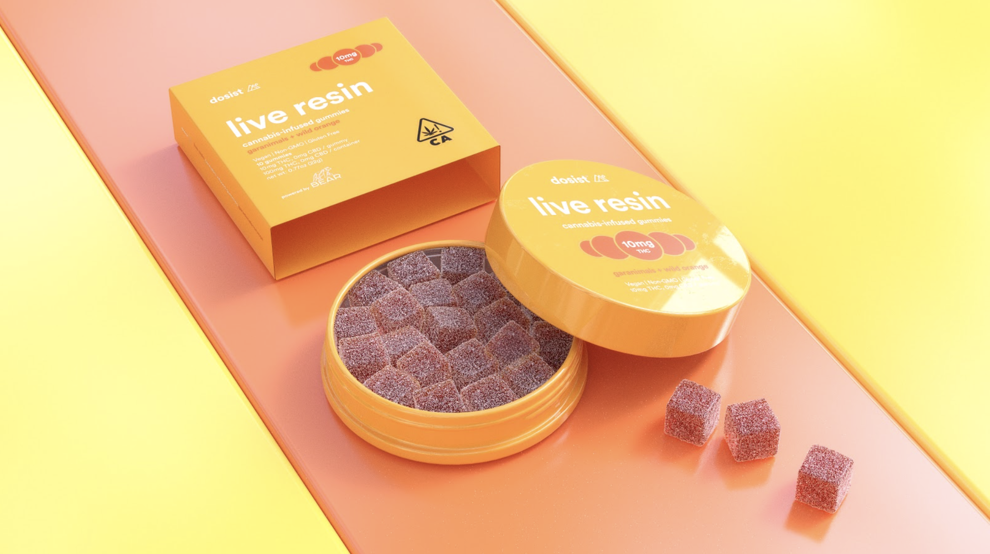 Open orange container of cannabis-infused gummy bears labeled 'Live Resin,' with three gummies outside the container on a pink and yellow background.