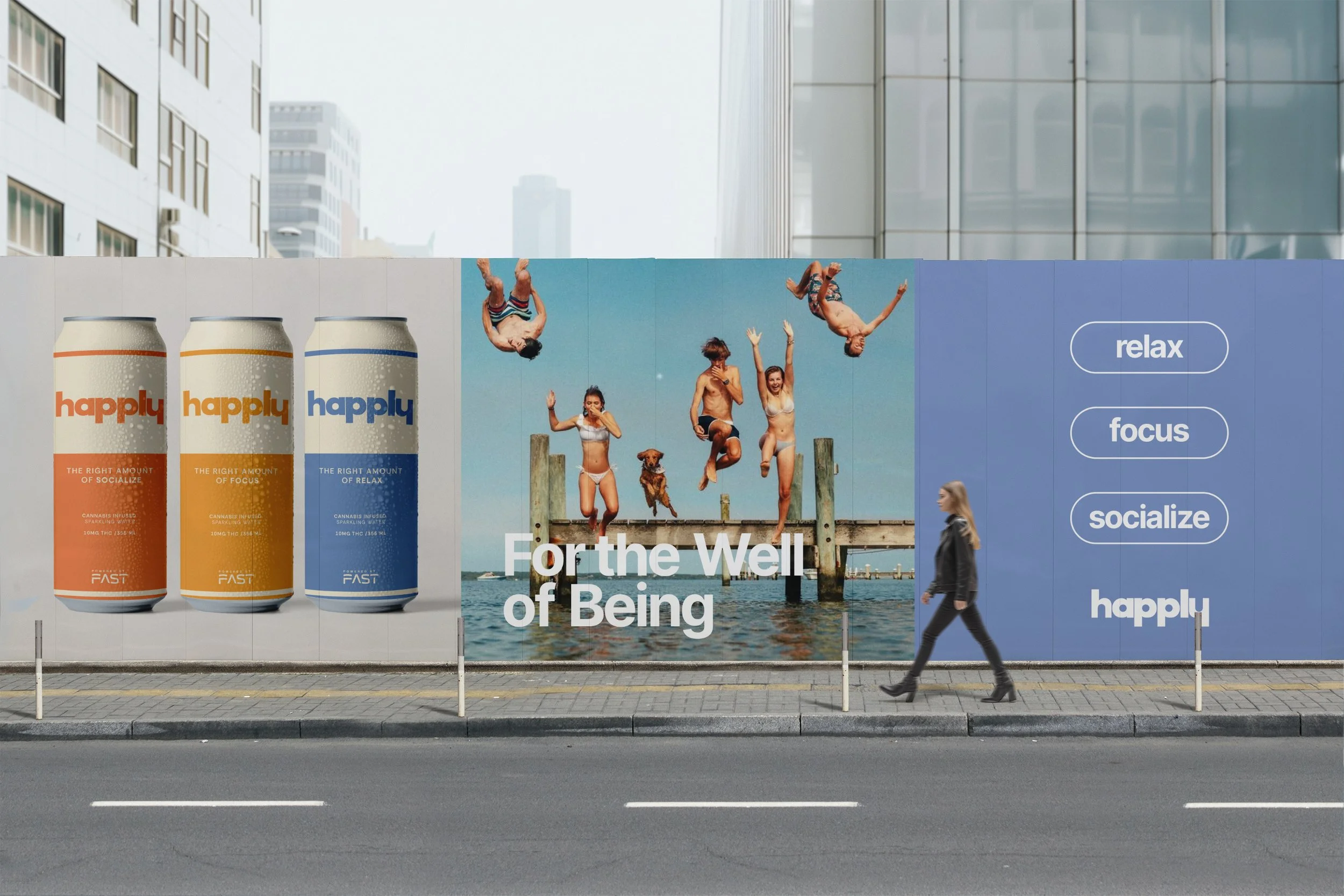 Advertisement billboard on a city street featuring three cans of a beverage called happily, an image of people jumping off a dock into water, and a person walking by. The billboard includes the phrases 'Forth the Well of Being', and words like relax, focus, socialize, happiness.