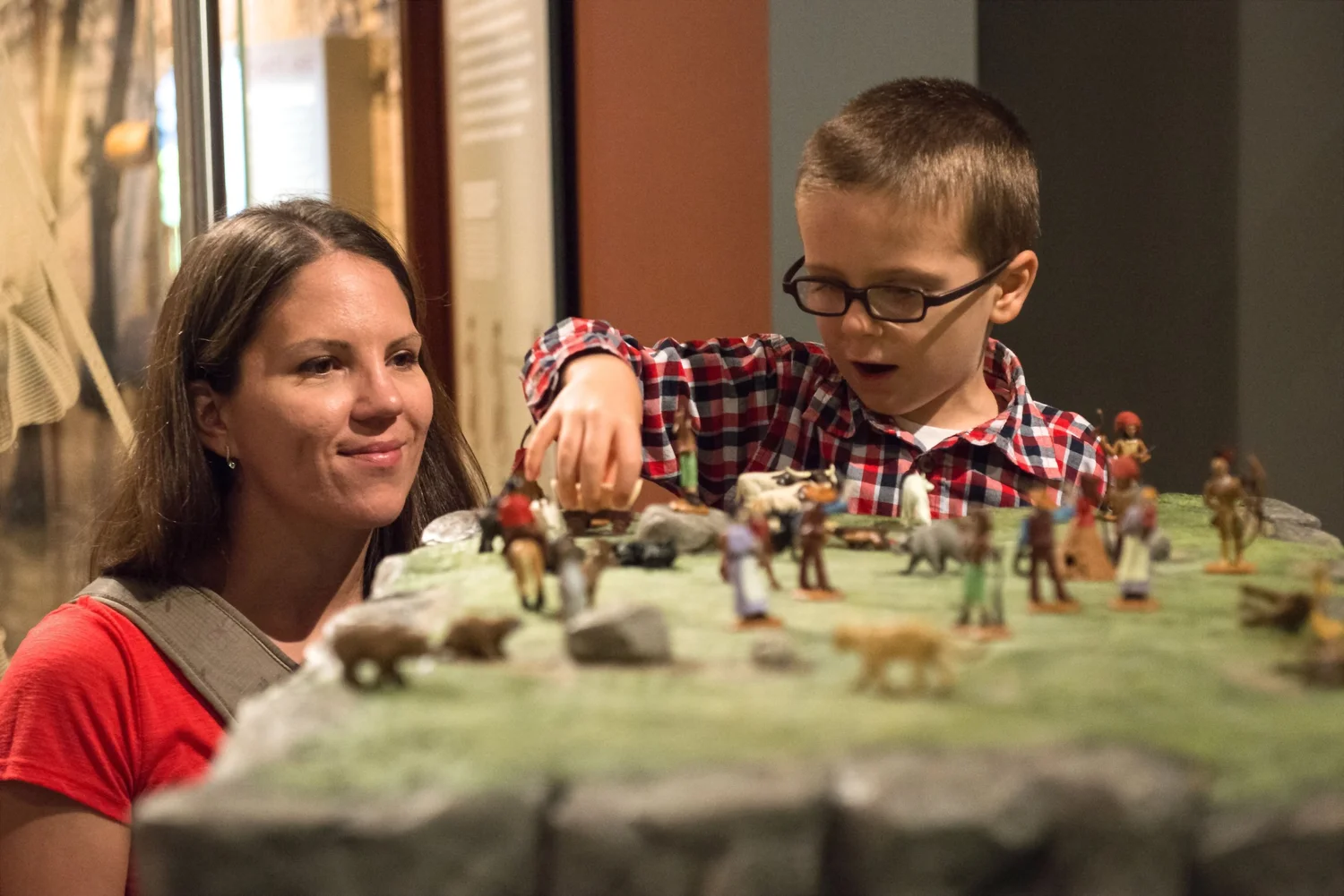 A mother and son viewing the toy soldier collection