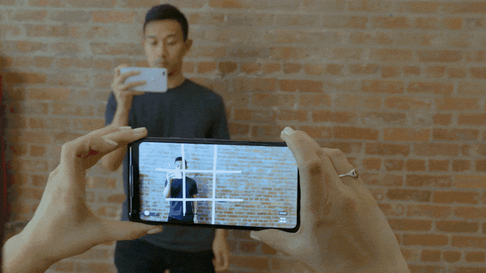 Players playing tic tac toe in a shared environment in AR