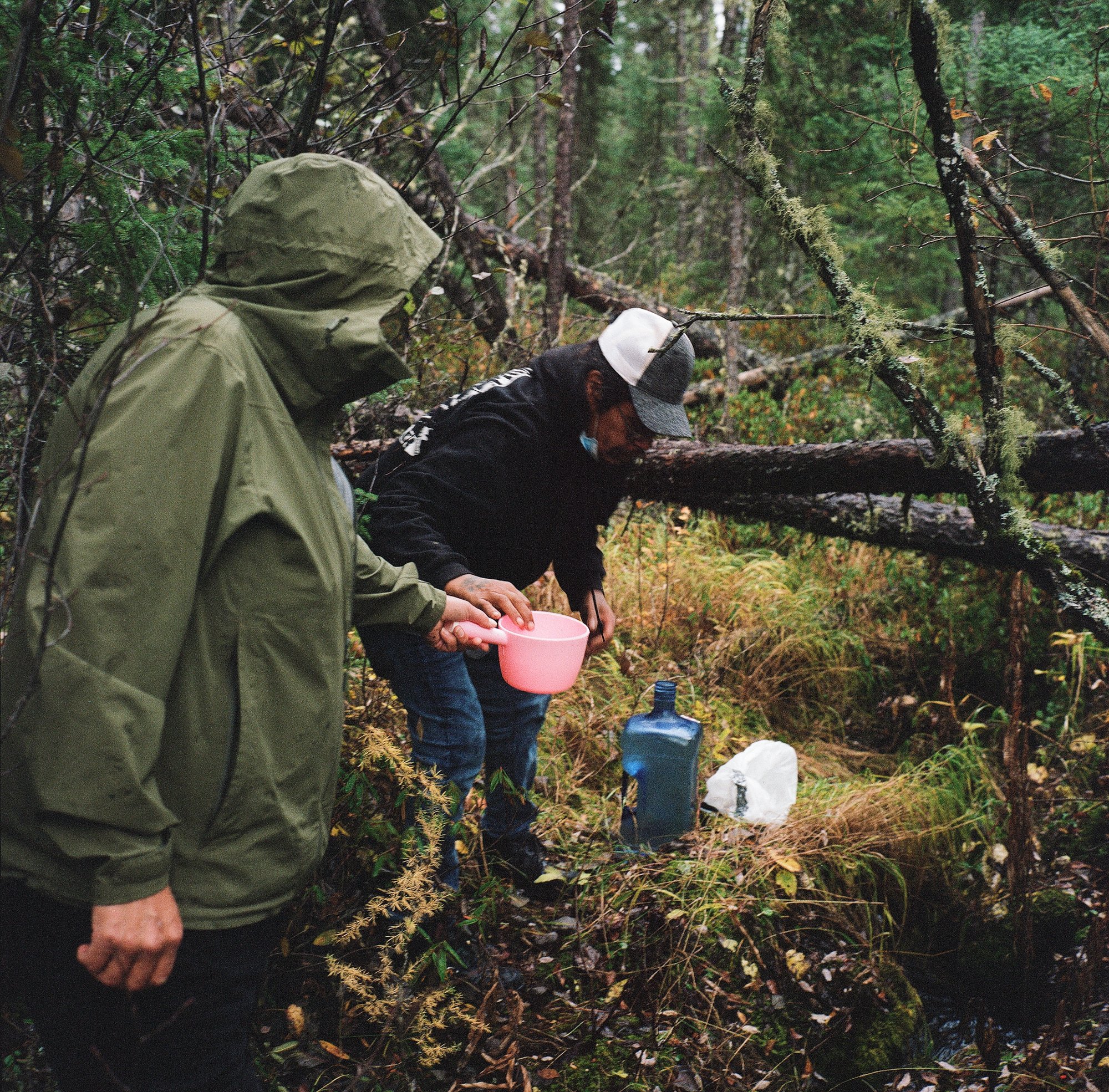 Derek Moonias fetches clean water with a friend from a fresh spring about an hour's drive from town.