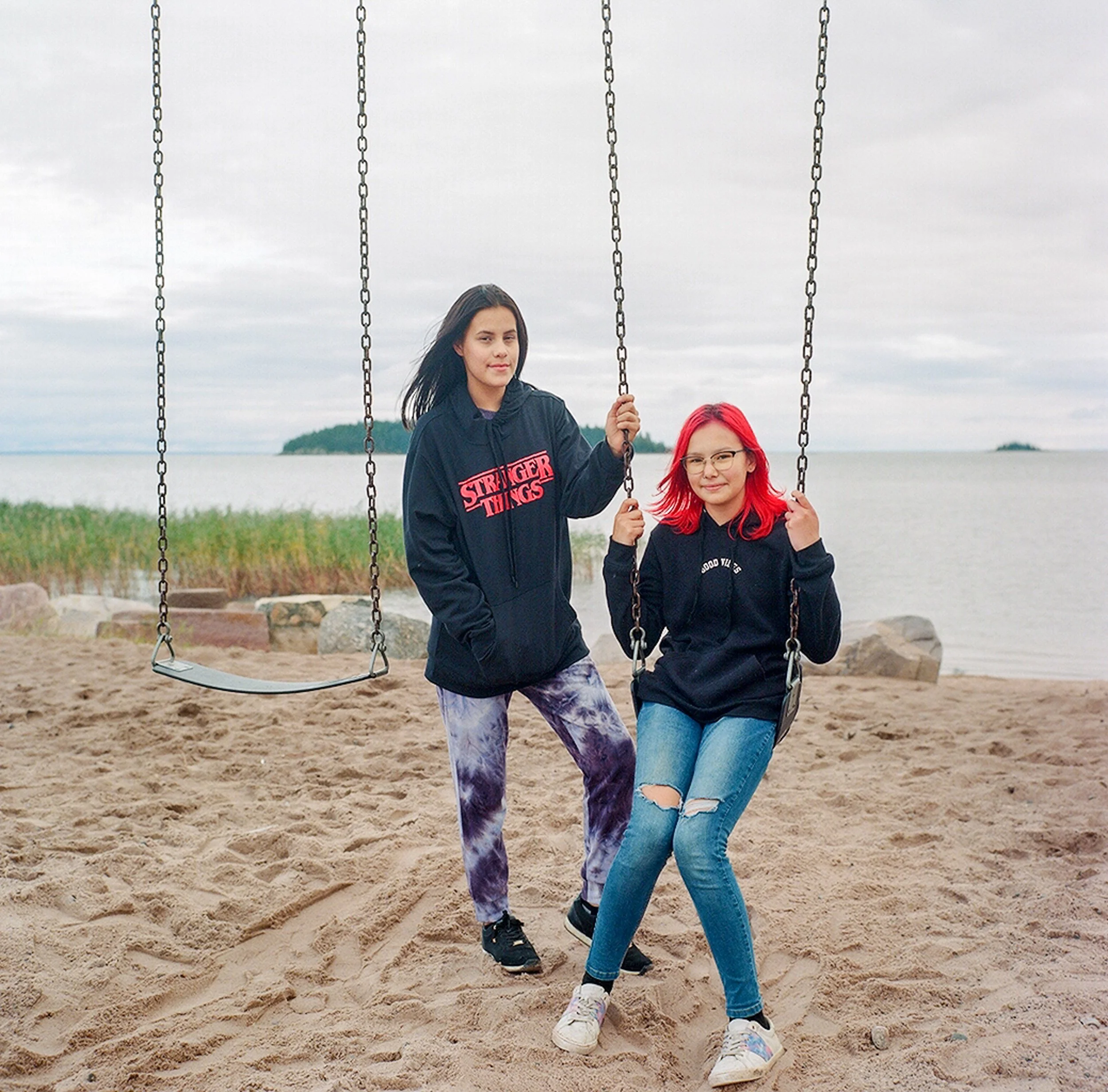 Friends play on the swingset in Fort Chipewyan along the shores of Lake Athabasca.