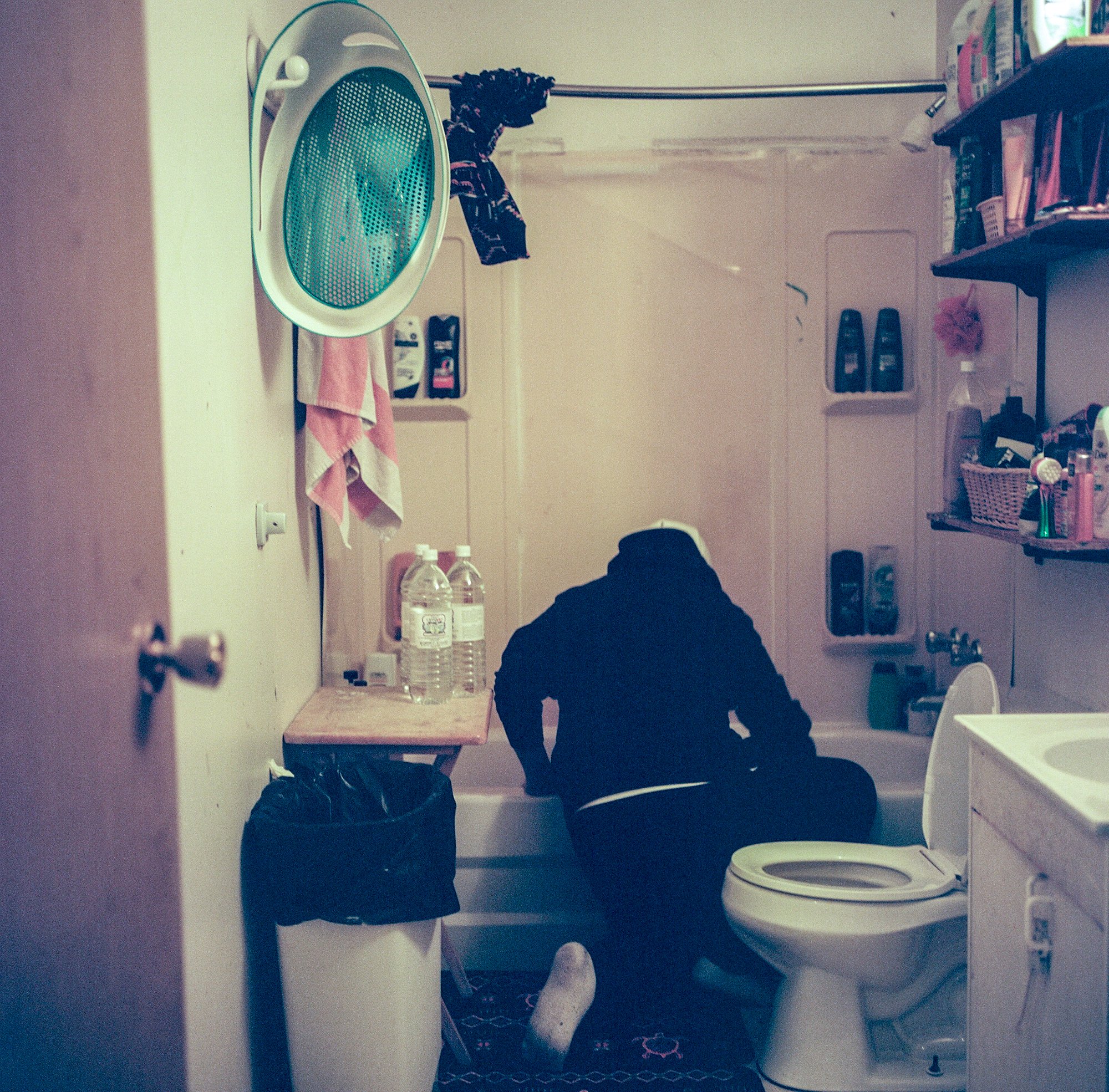 Martin Anges prepares to bathe his newborn baby with boiled bottled water.
