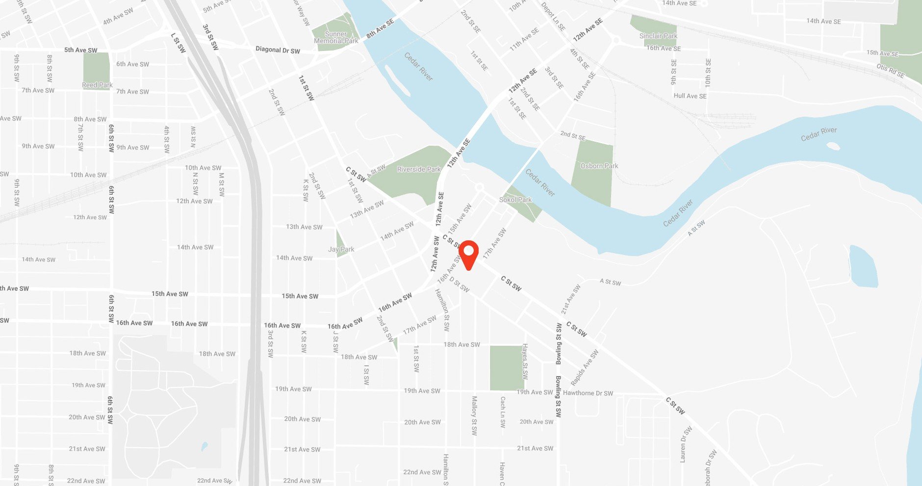 Map showing streets, parks, and waterways in an area with a red location marker at the intersection of 16th Ave SW and C St. SW near Cedar River in Cedar Rapids, Iowa..