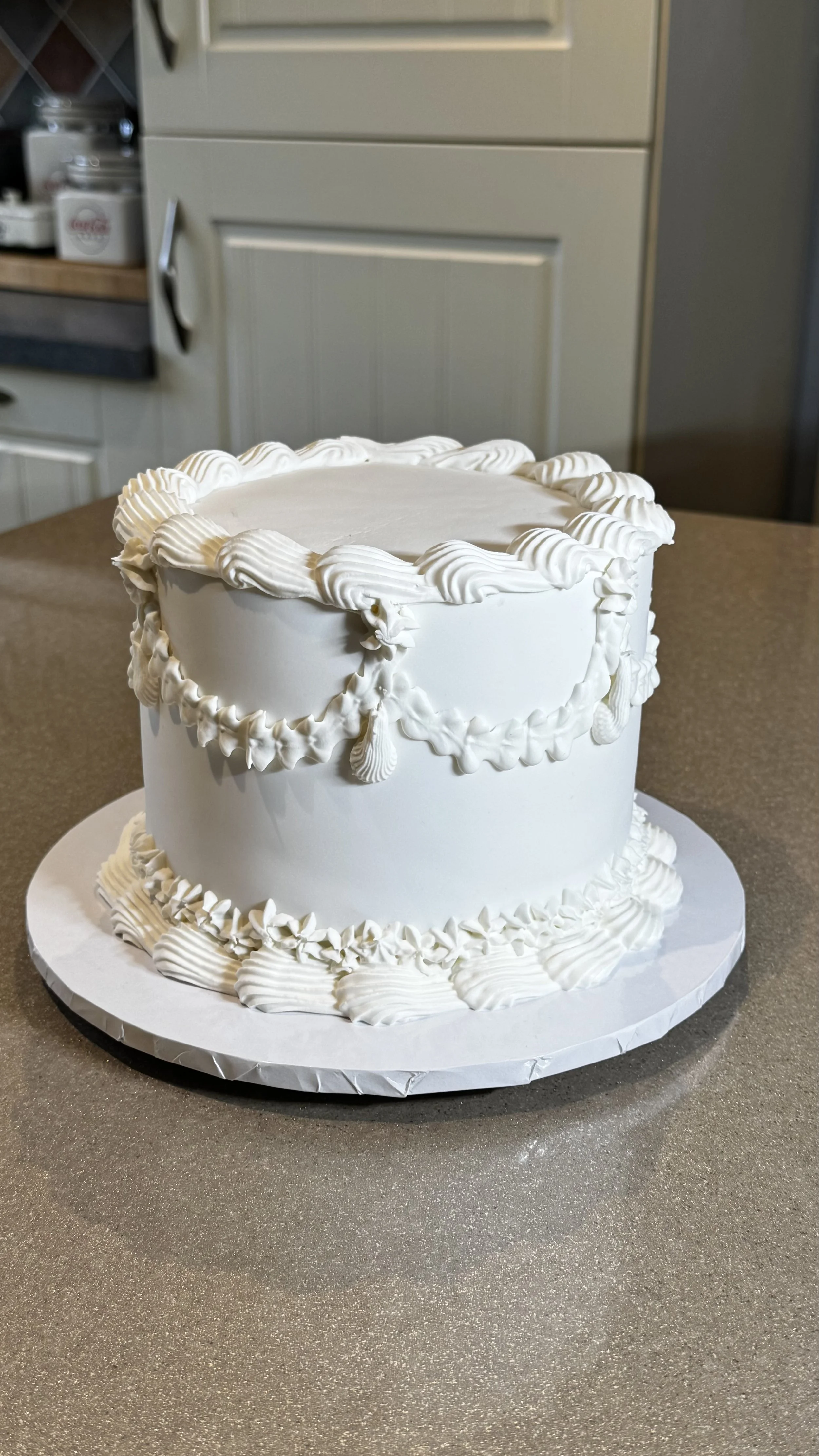 Vintage style wedding or anniversary cake with all white with royal icing.