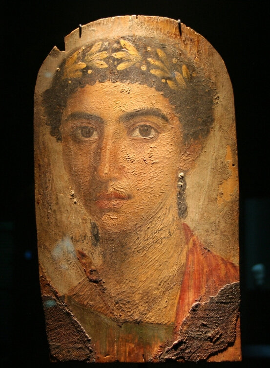 A portrait of the Fayum.  The Fayum Mummy Portraits are a type of naturalistic portrait painted on wooden planks attached to upper class mummies from Roman Egypt.  They belong to the tradition of panel painting, one of the most popular art forms in the classical world.  The portraits of the Fayum are the only large body of art from this tradition to have survived.