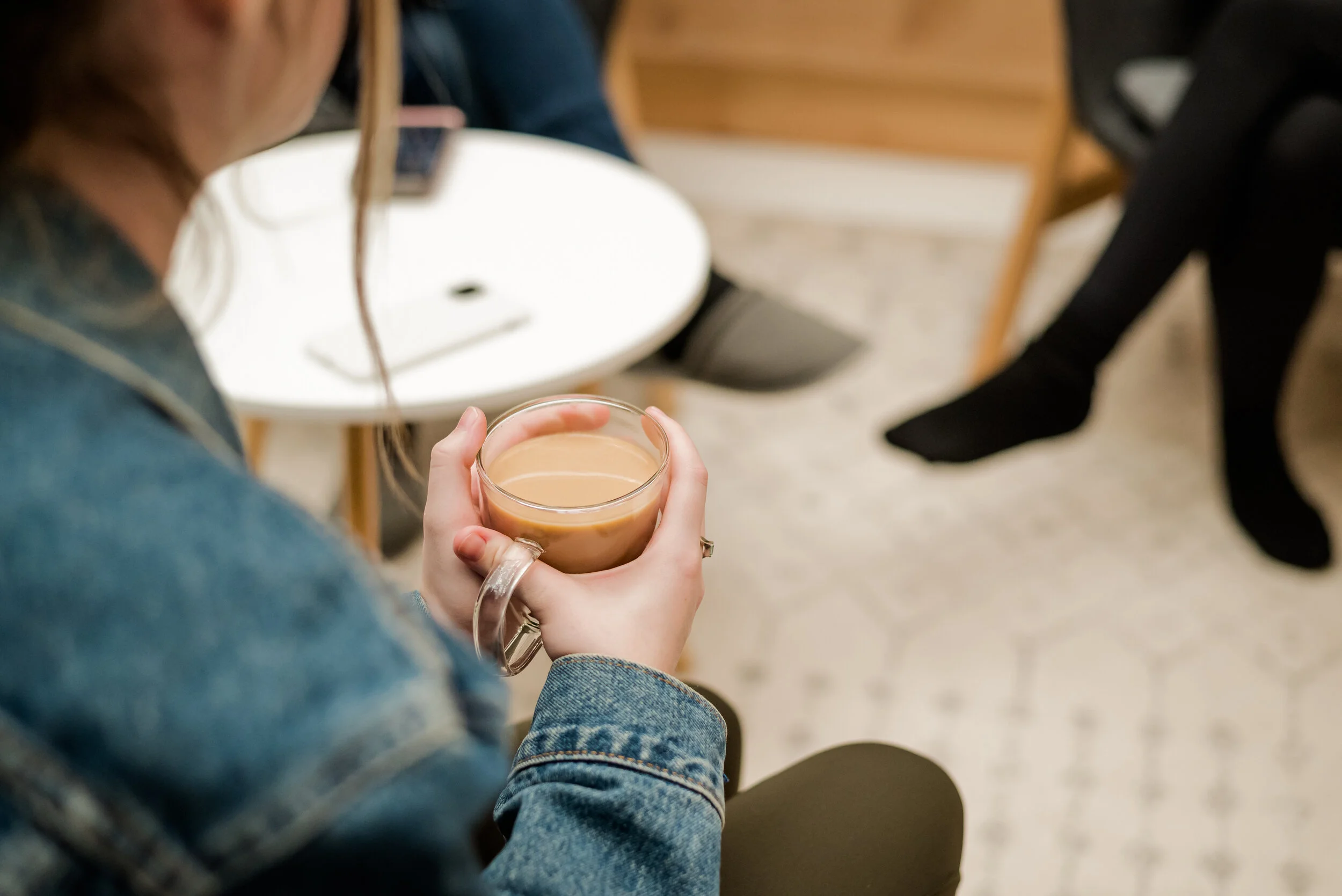 Coworking with unlimited coffee, person holding coffee in office