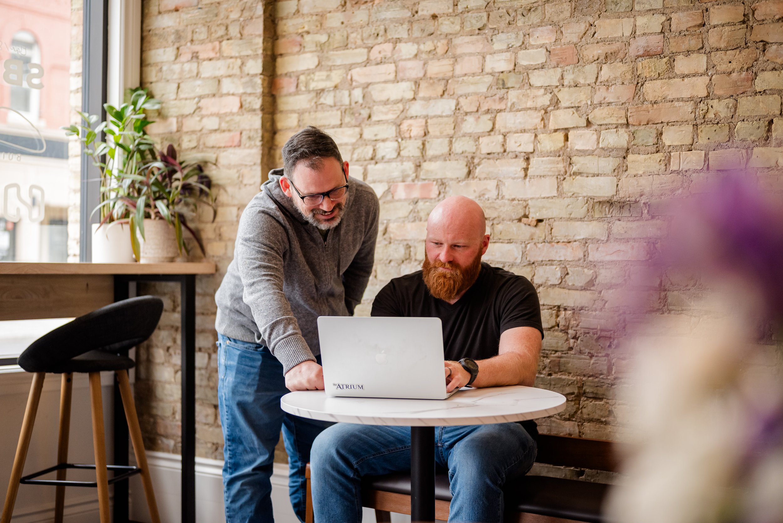 Coworkers laughing and working together, built in business support