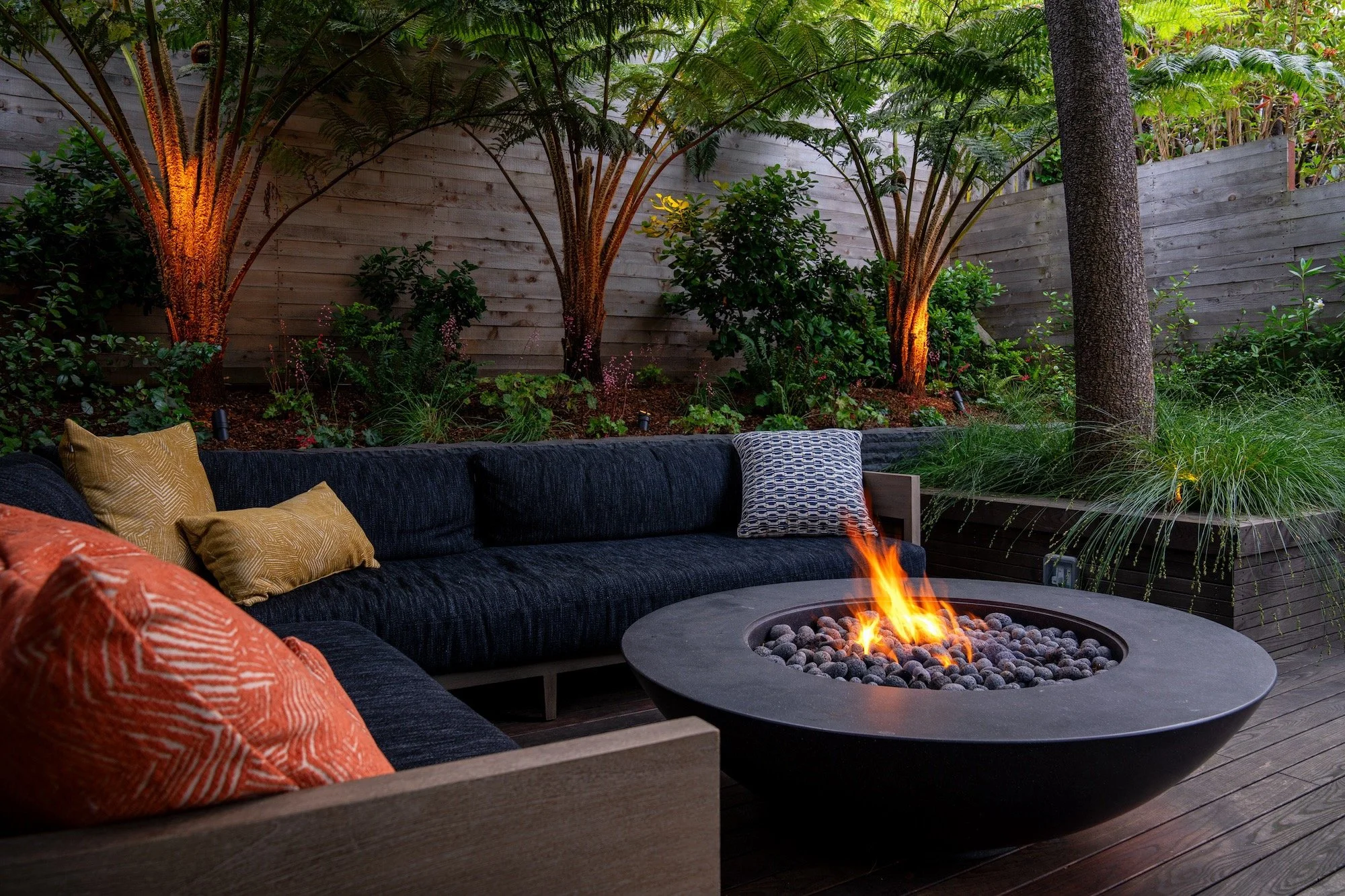 Lounge sectional seating with firepit in the evening in Corona Heights