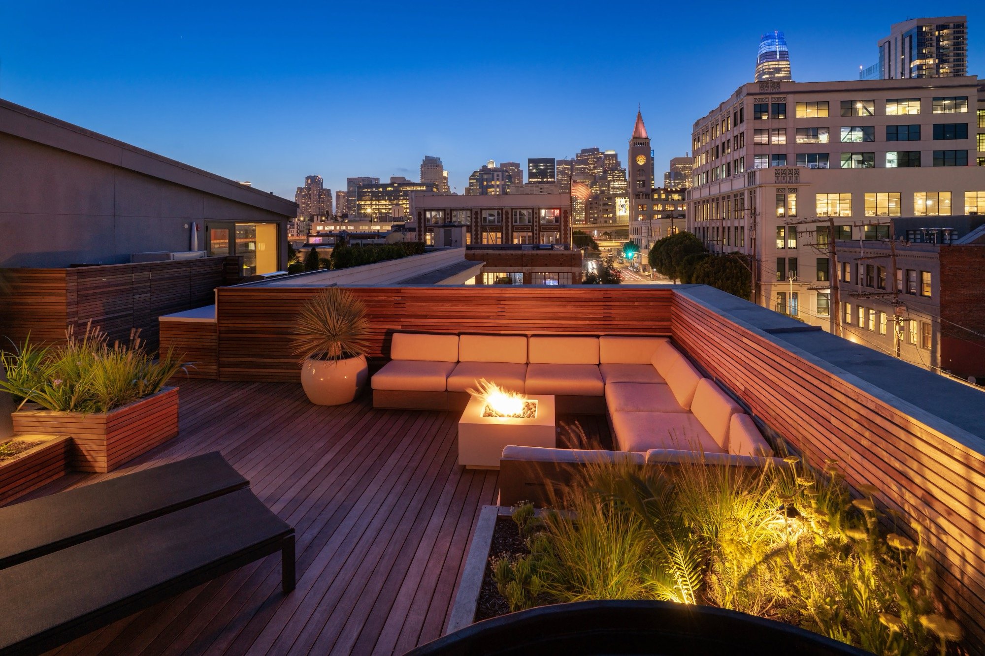 Roof terrace with city lights view and firepit at night in San Francisco