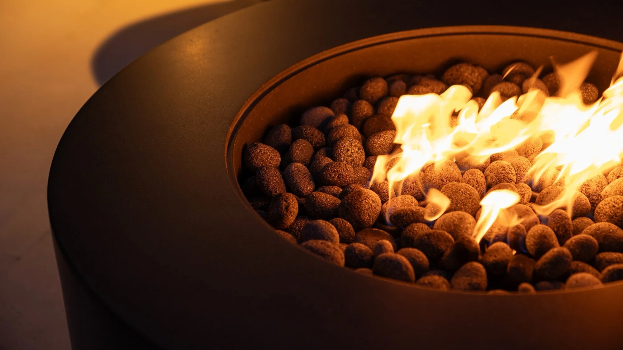 Modern prefabricated concrete firepit at night