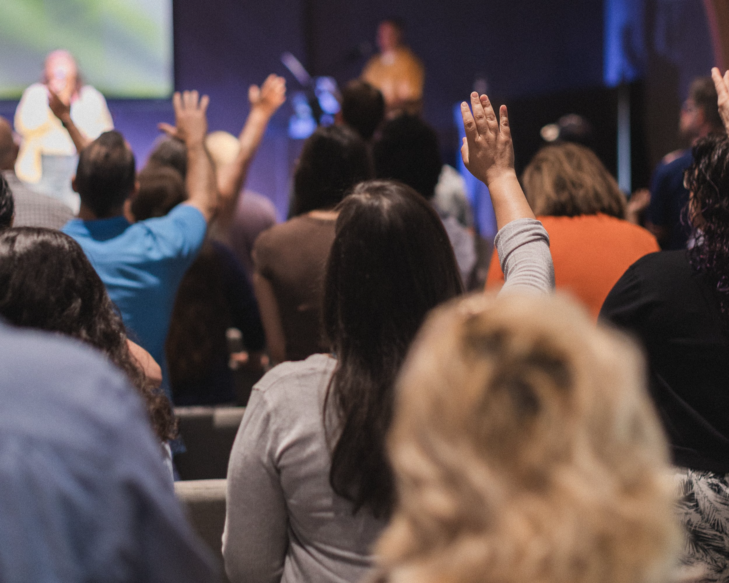Hands lifted in worship at Bethel Assembly Church in Elmhurst, IL during a worship service.